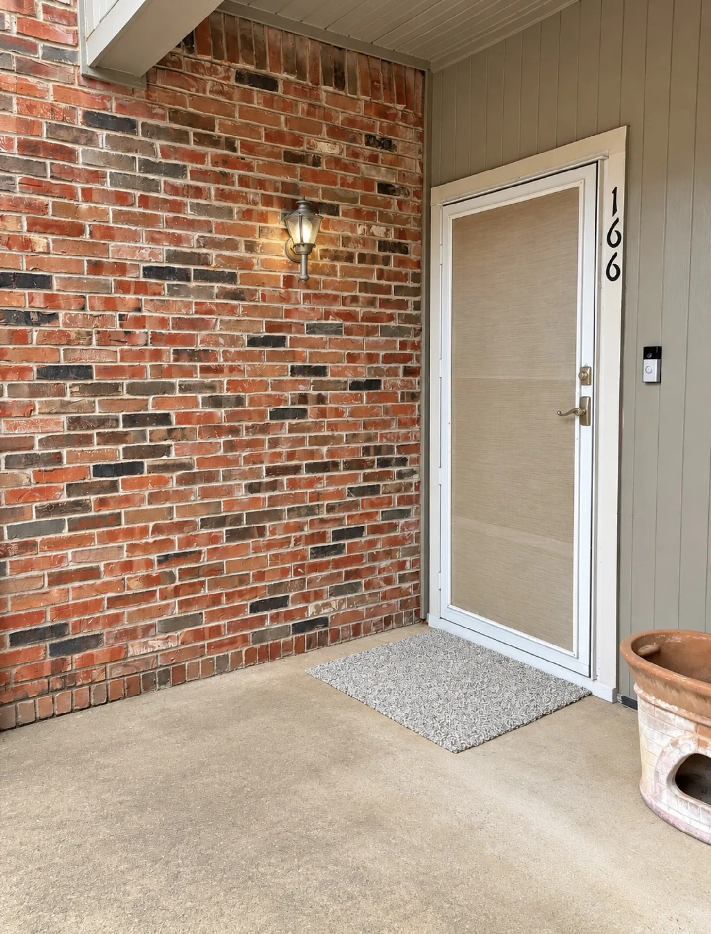 Brick exterior wall with a wall-mounted light fixture