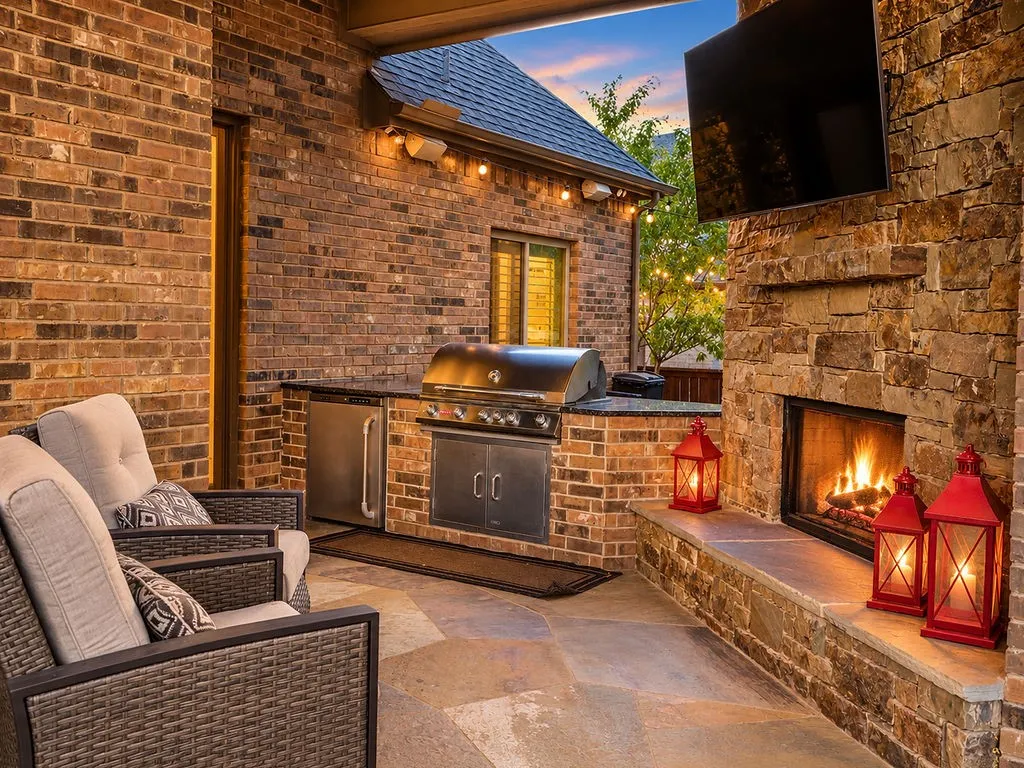 Patio with outdoor kitchen, fireplace and wired for tv.