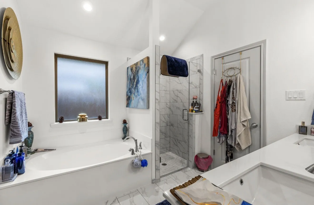 Soaking tub with a frosted window and deck-mounted faucet