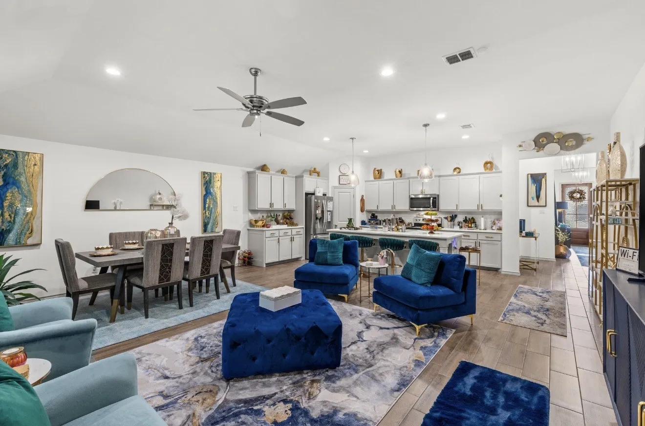 Open-concept living space with wood-finish flooring, a contemporary ceiling fan, and recessed lighting