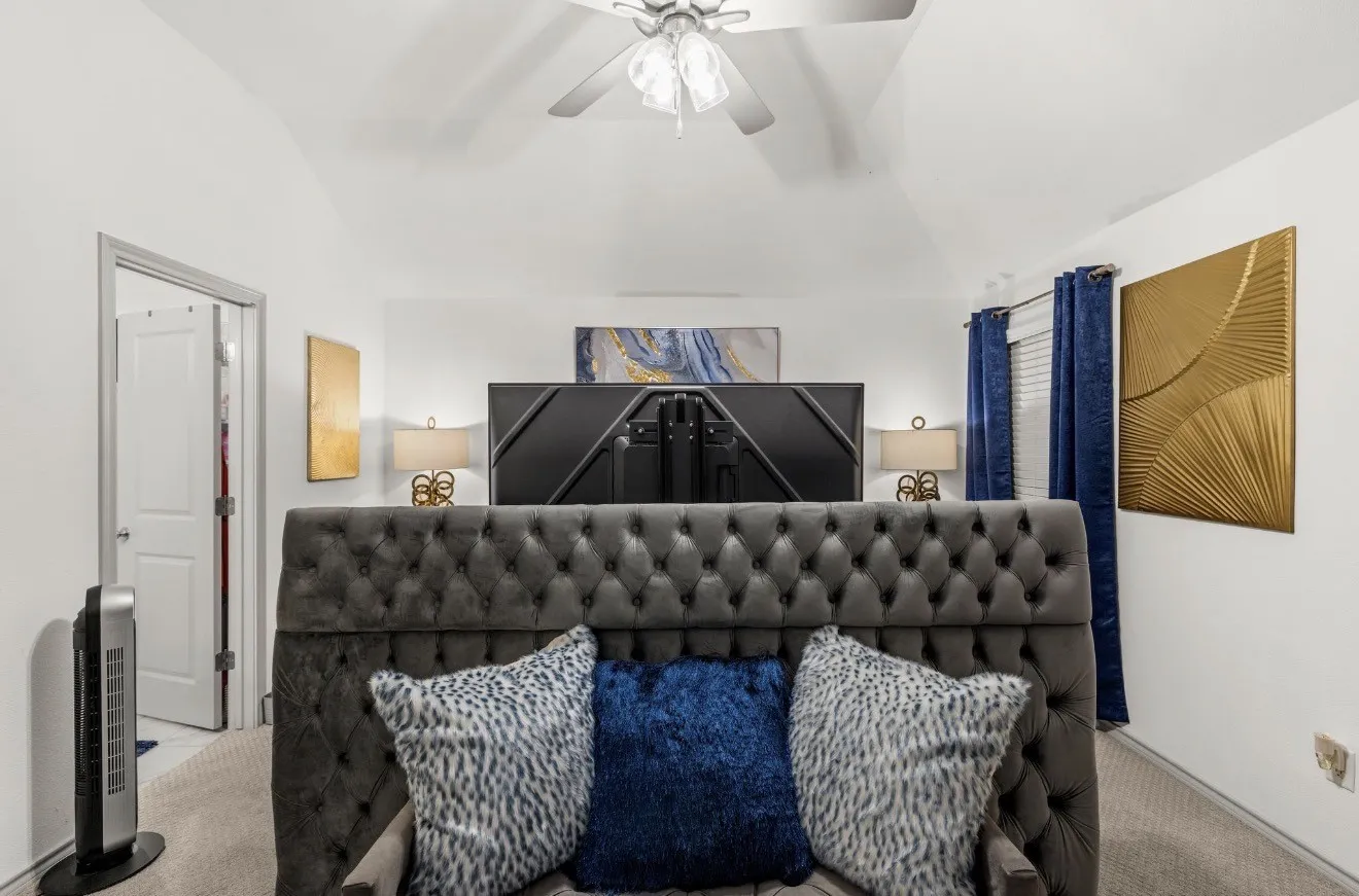 Vaulted ceiling with a ceiling fan, white paneled interior doors, and neutral carpeting