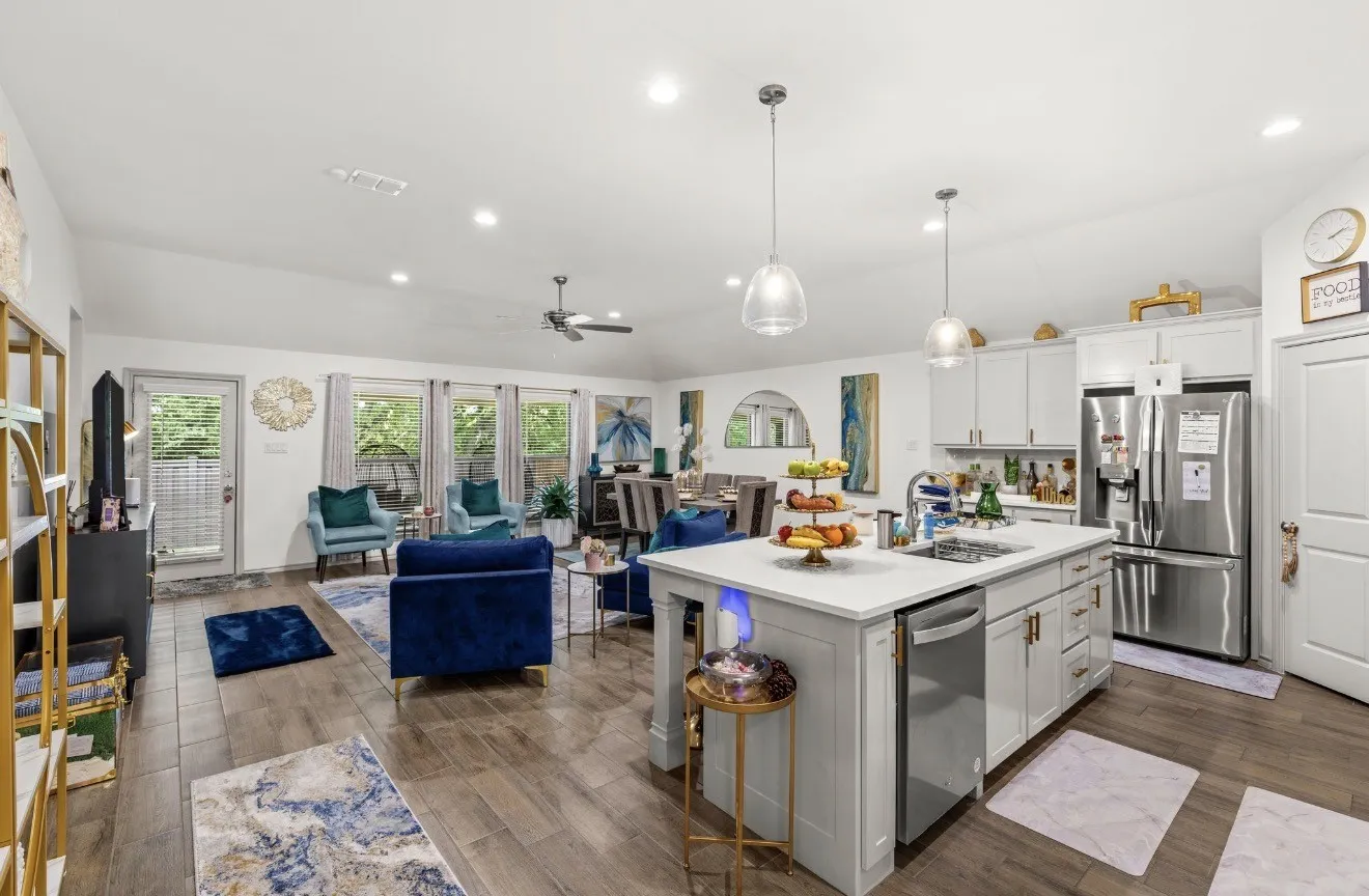 Open-concept living space featuring wood-finish flooring, recessed lighting, and a ceiling fan