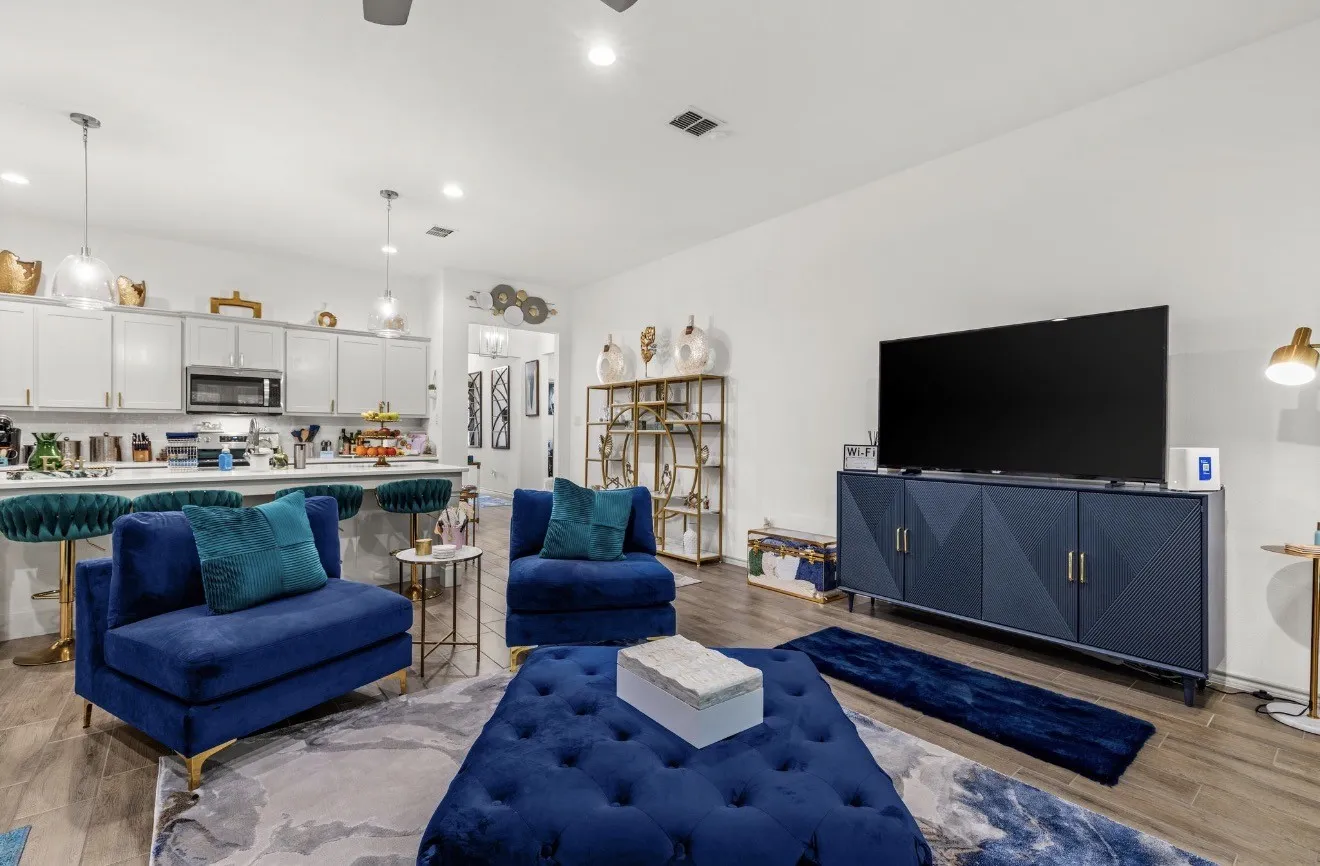 Open-concept living area with wood-finish flooring, recessed lighting, and a ceiling fan