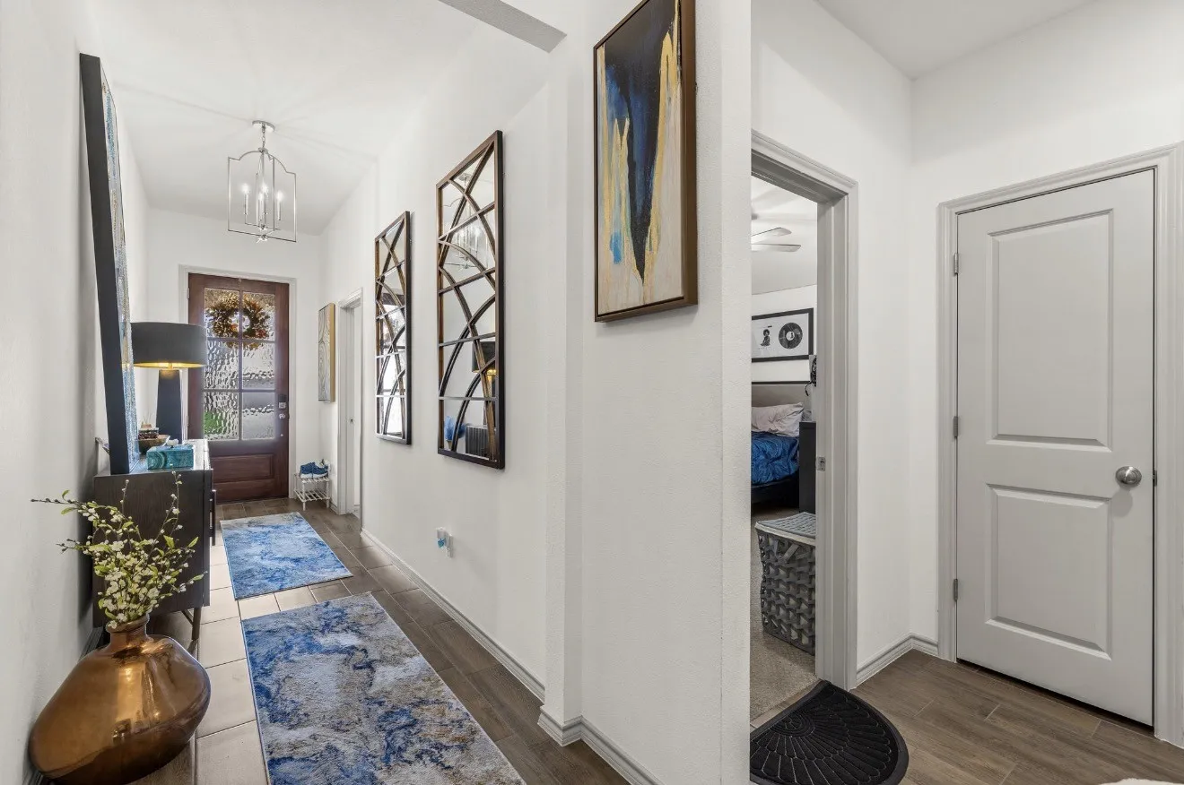 Wood-finish flooring throughout the hallway