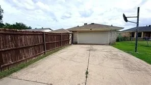 Concrete driveway leading to an attached garage