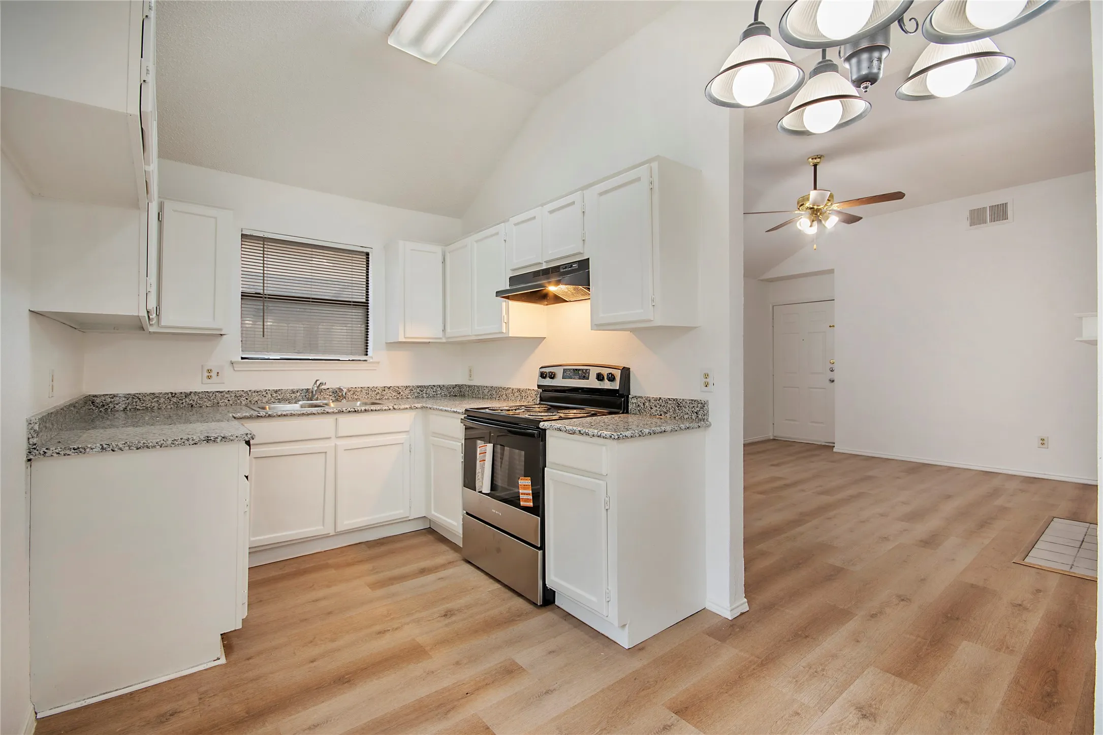 Kitchen featuring white cabinetry, light-toned countertops, and stainless steel appliances