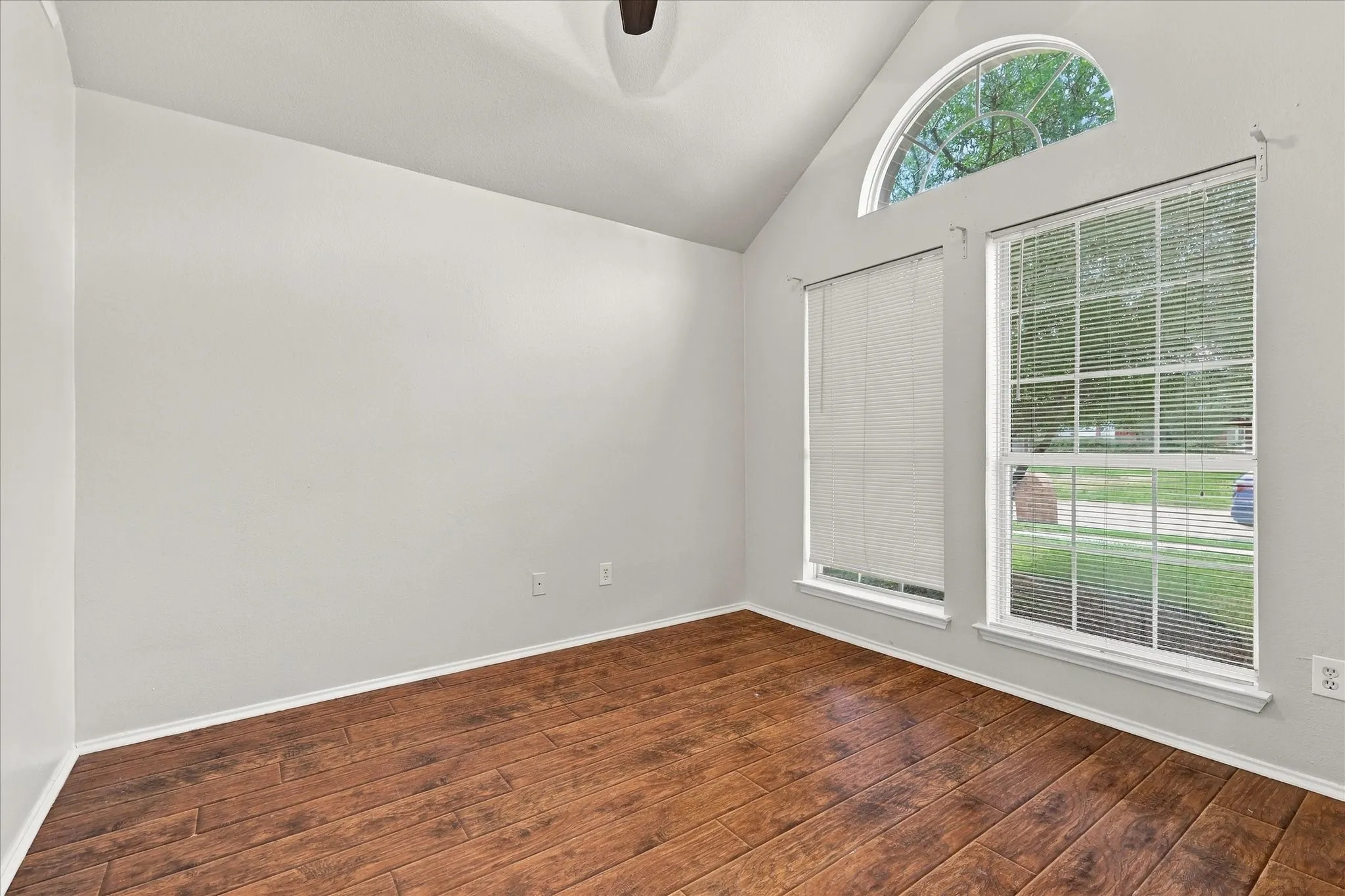 Front Bedroom with vaulted ceiling, ceiling fan and built-in shelving.