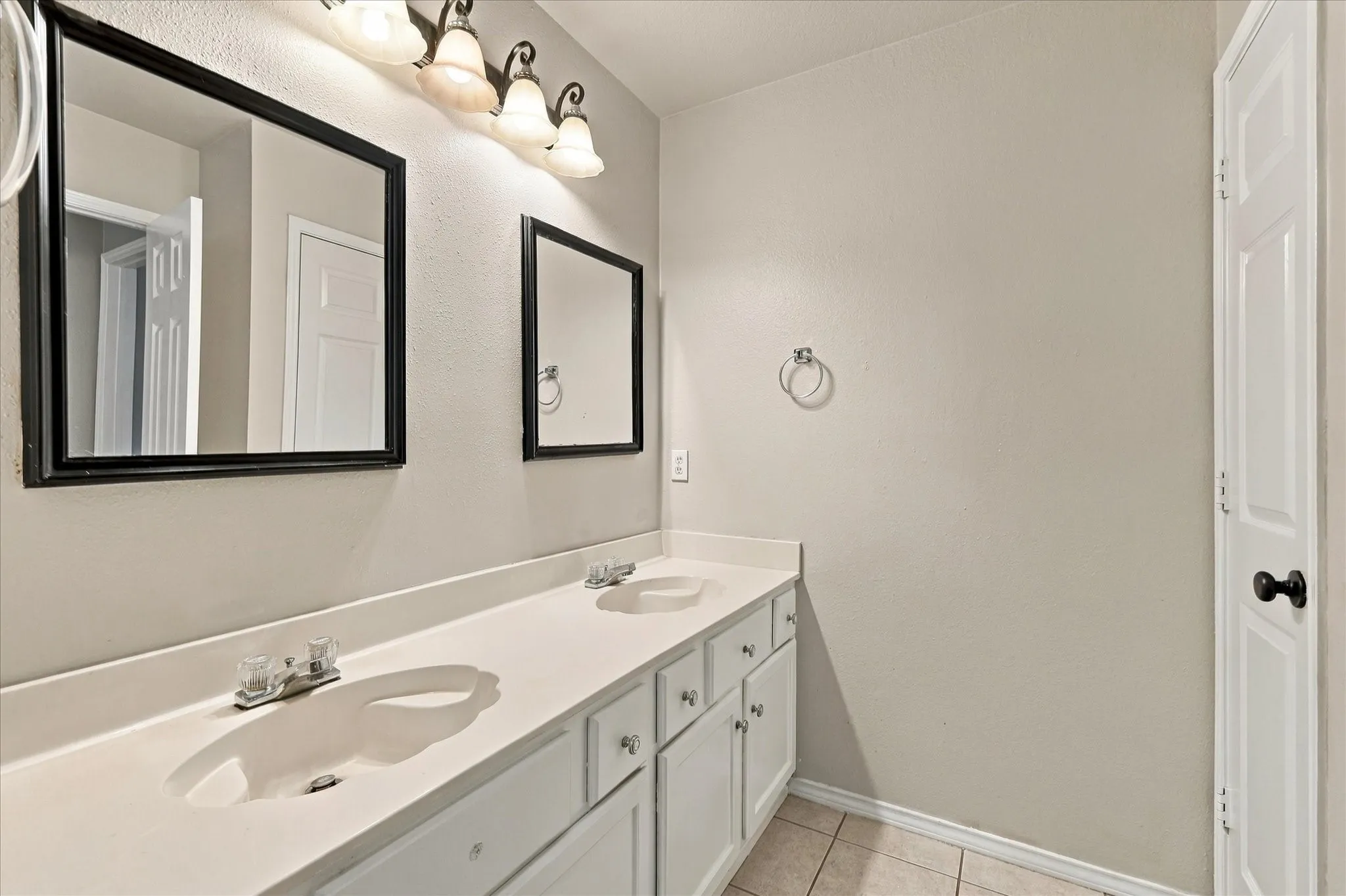Hall bathroom featuring dual sinks, ample counter space and tub/shower combo.