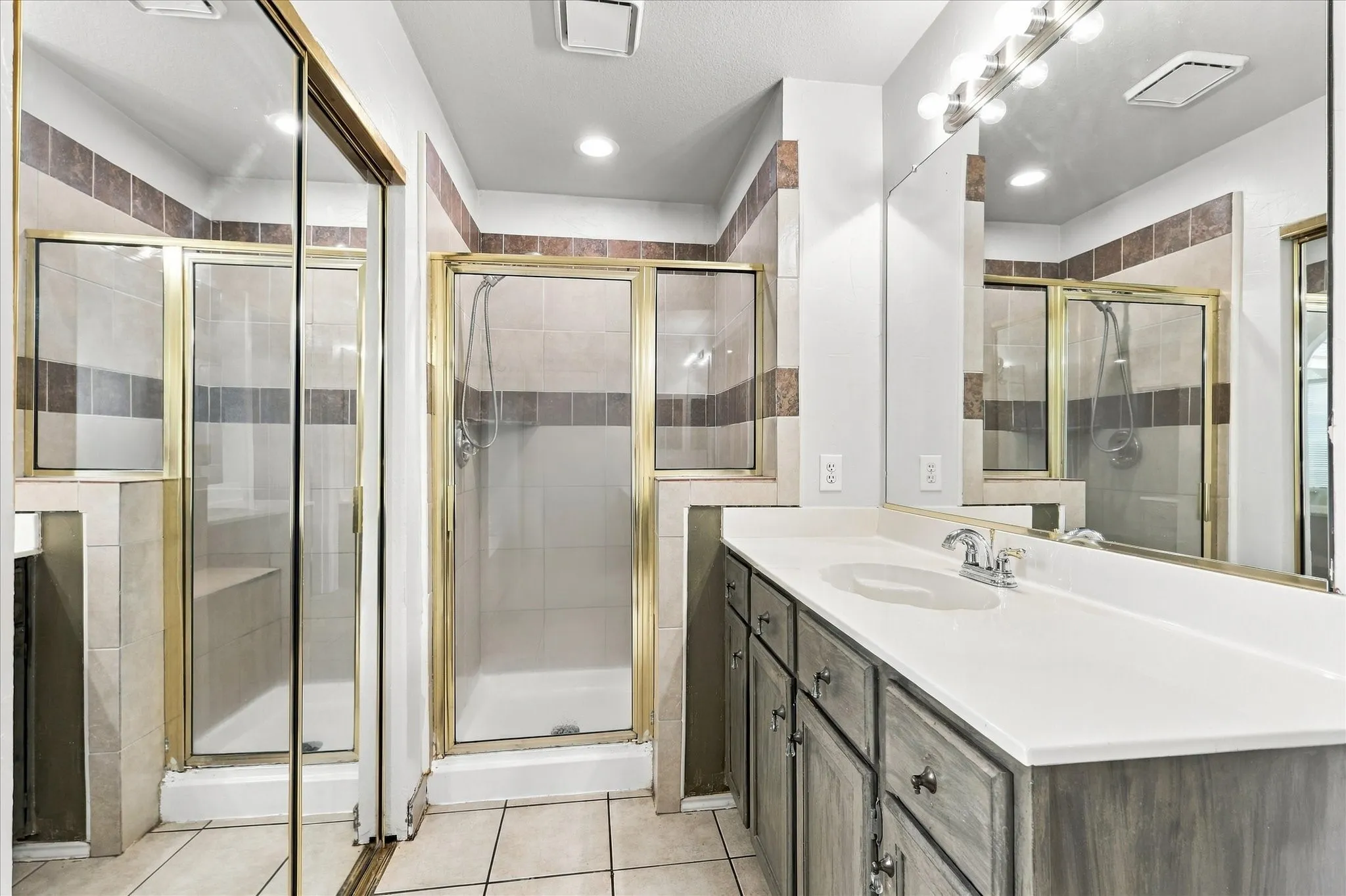 the primary bath offers separate vanities, a garden tub and separate shower.