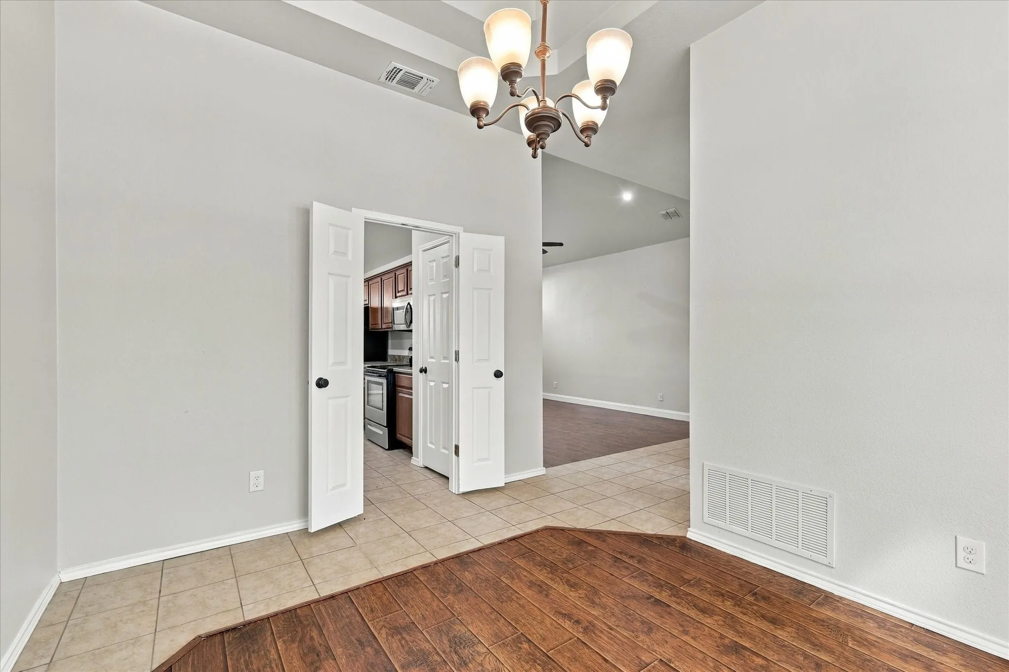 The formal dining room adds an elegant touch with its three-tier tray ceiling, bay window and decorative lighting.