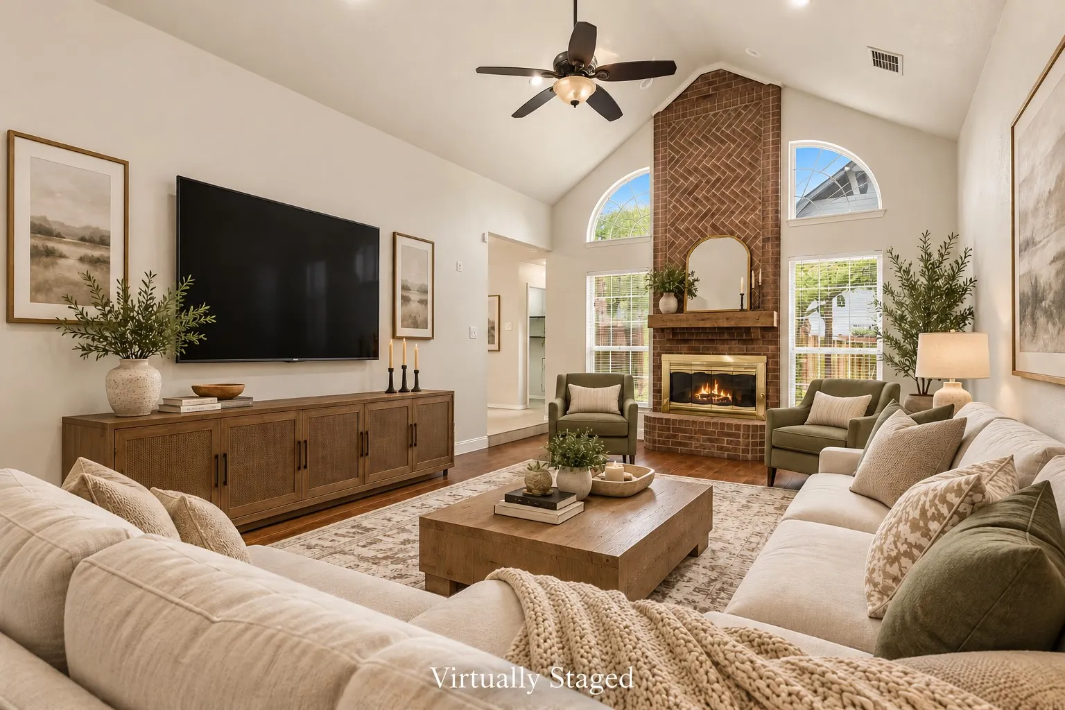 Virtually Staged.  The unique step-down living room is designed to be the gathering space of the home, featuring vaulted ceilings, warm laminate flooring, recessed lighting, ceiling fan and a dramatic floor-to-ceiling brick gas fireplace with raised hearth and wood mantel, beautifully framed by windows.
