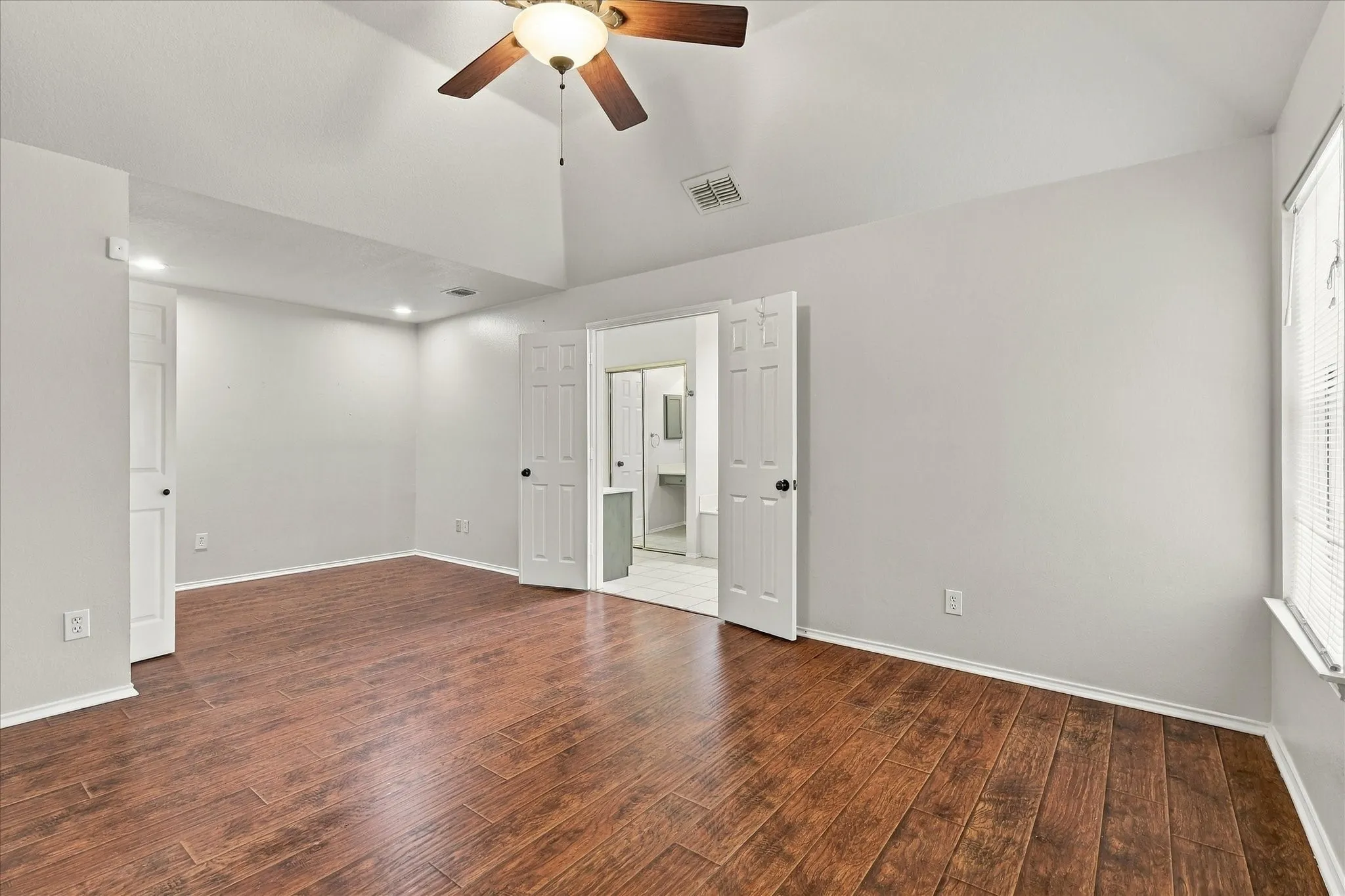 The spacious primary suite includes a sitting area and THREE closets, while the primary bath offers separate vanities, a garden tub and separate shower.