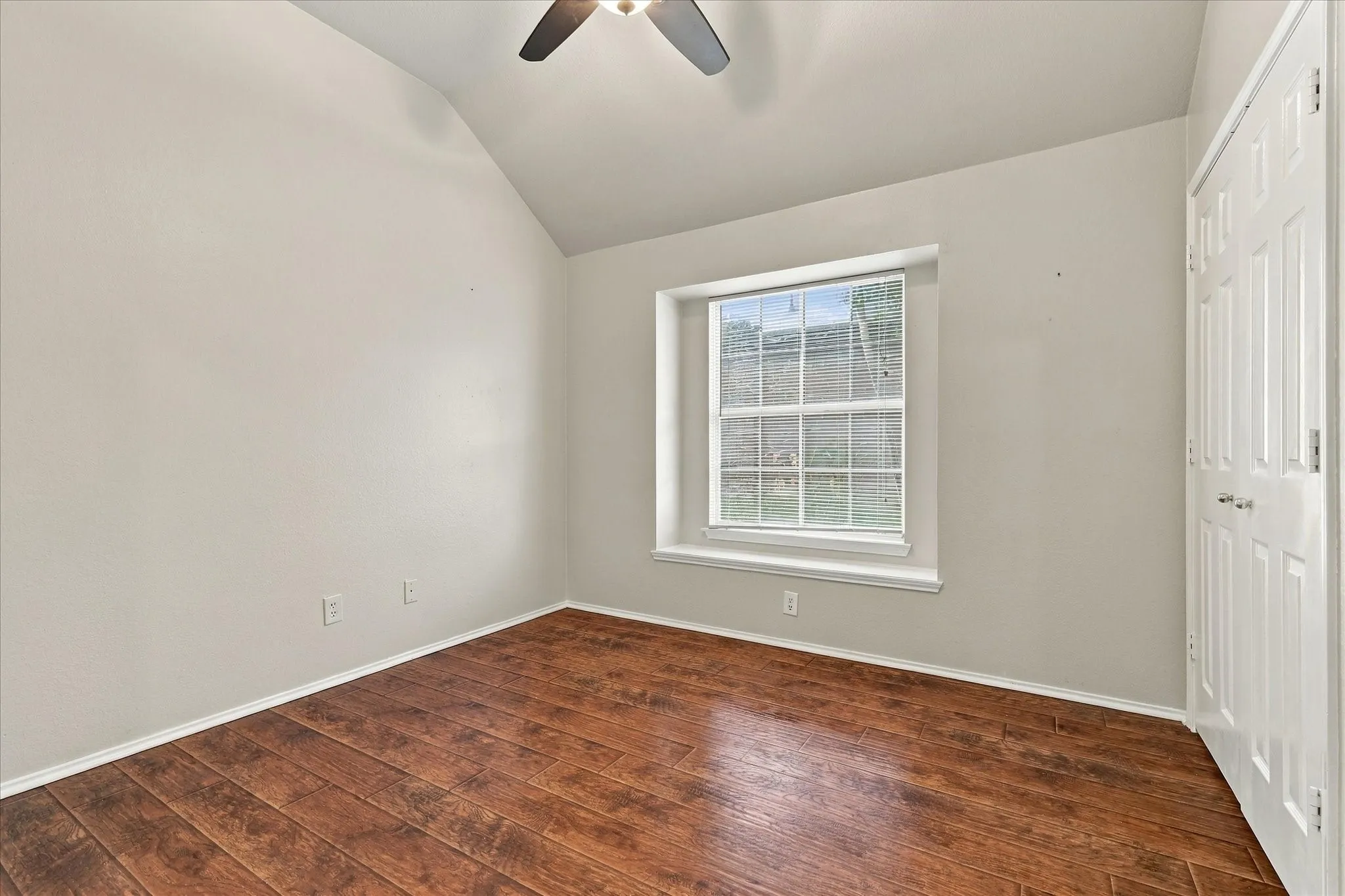 Middle Bedroom featuring vaulted ceiling and ceiling fan
