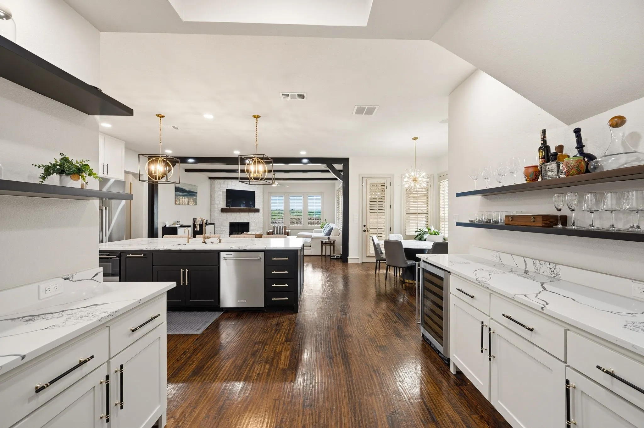 White perimeter cabinetry with quartz countertops and a built-in wine refrigerator