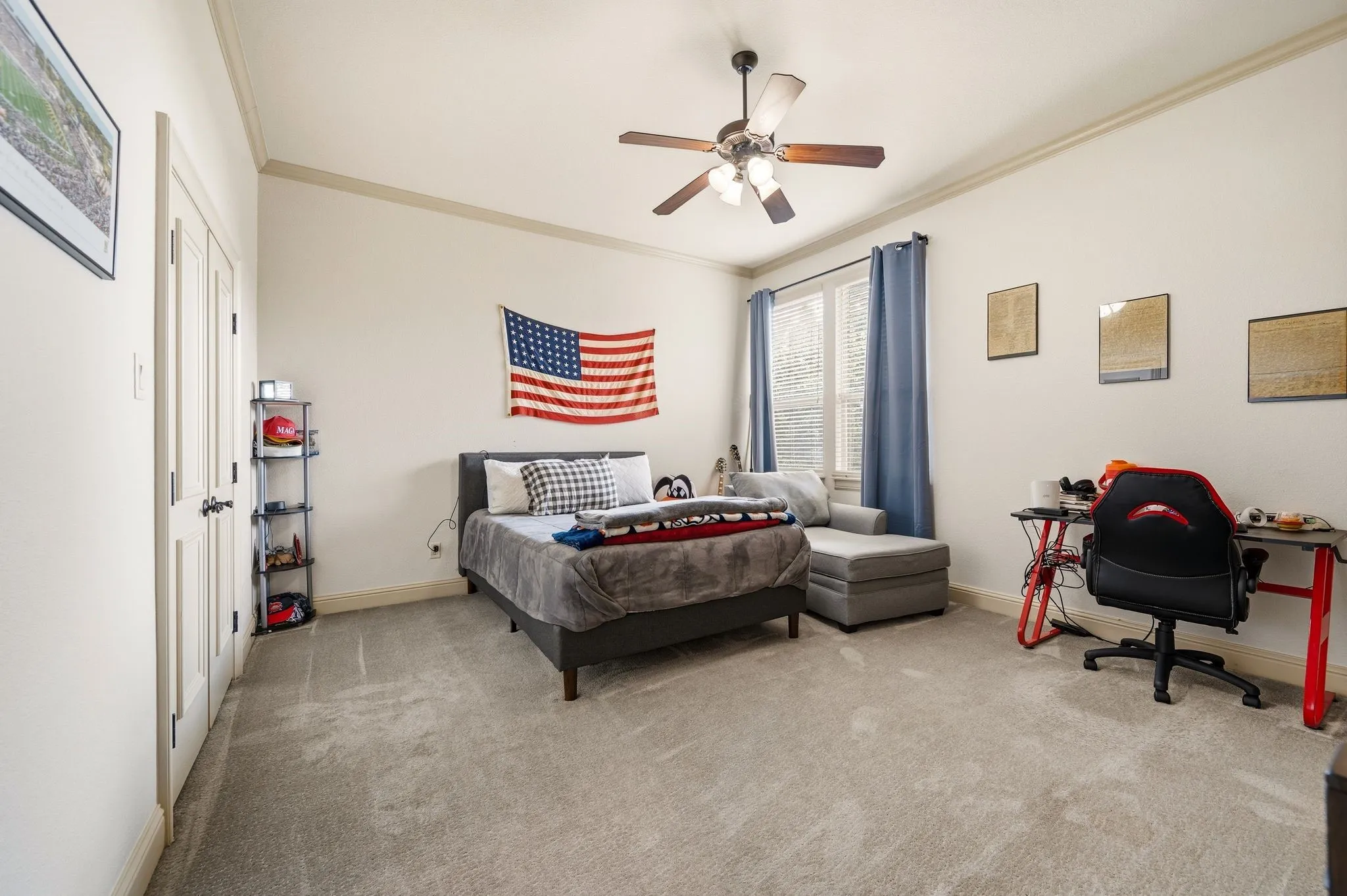 Neutral tone wall paint, light-colored carpeting, a ceiling fan with integrated lighting, and crown molding