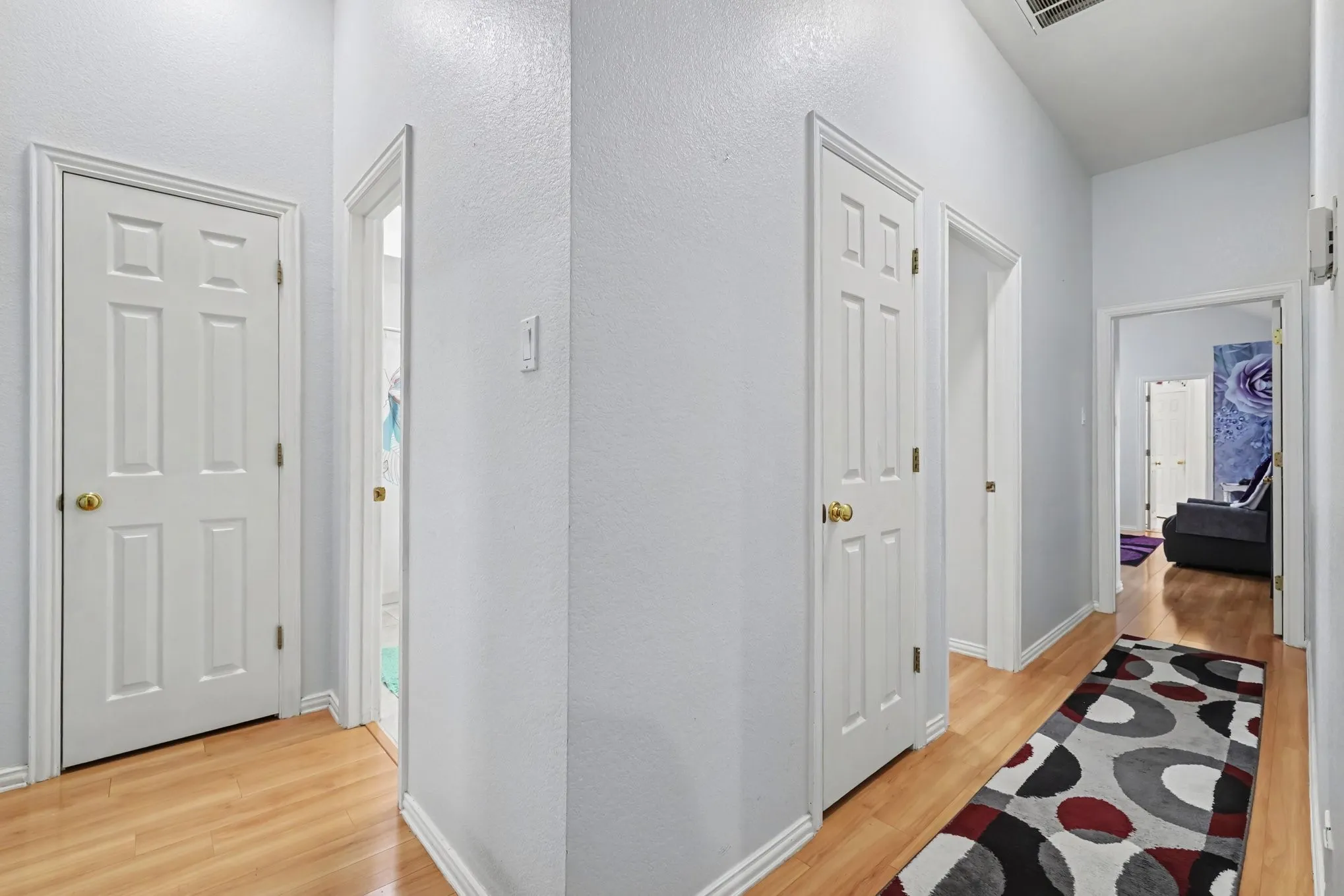 Wood-finish flooring throughout the hallway