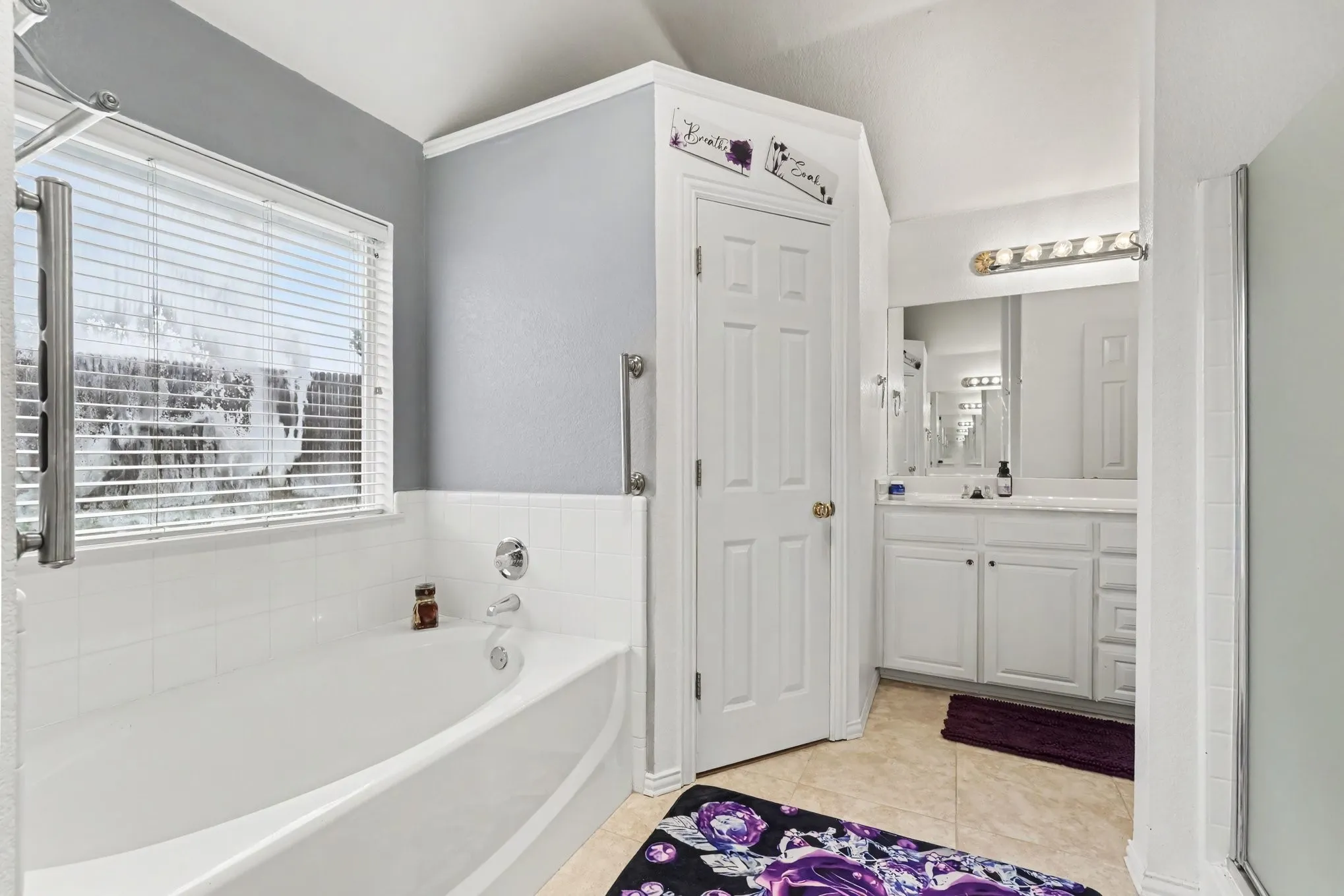 White bathtub with tiled surround