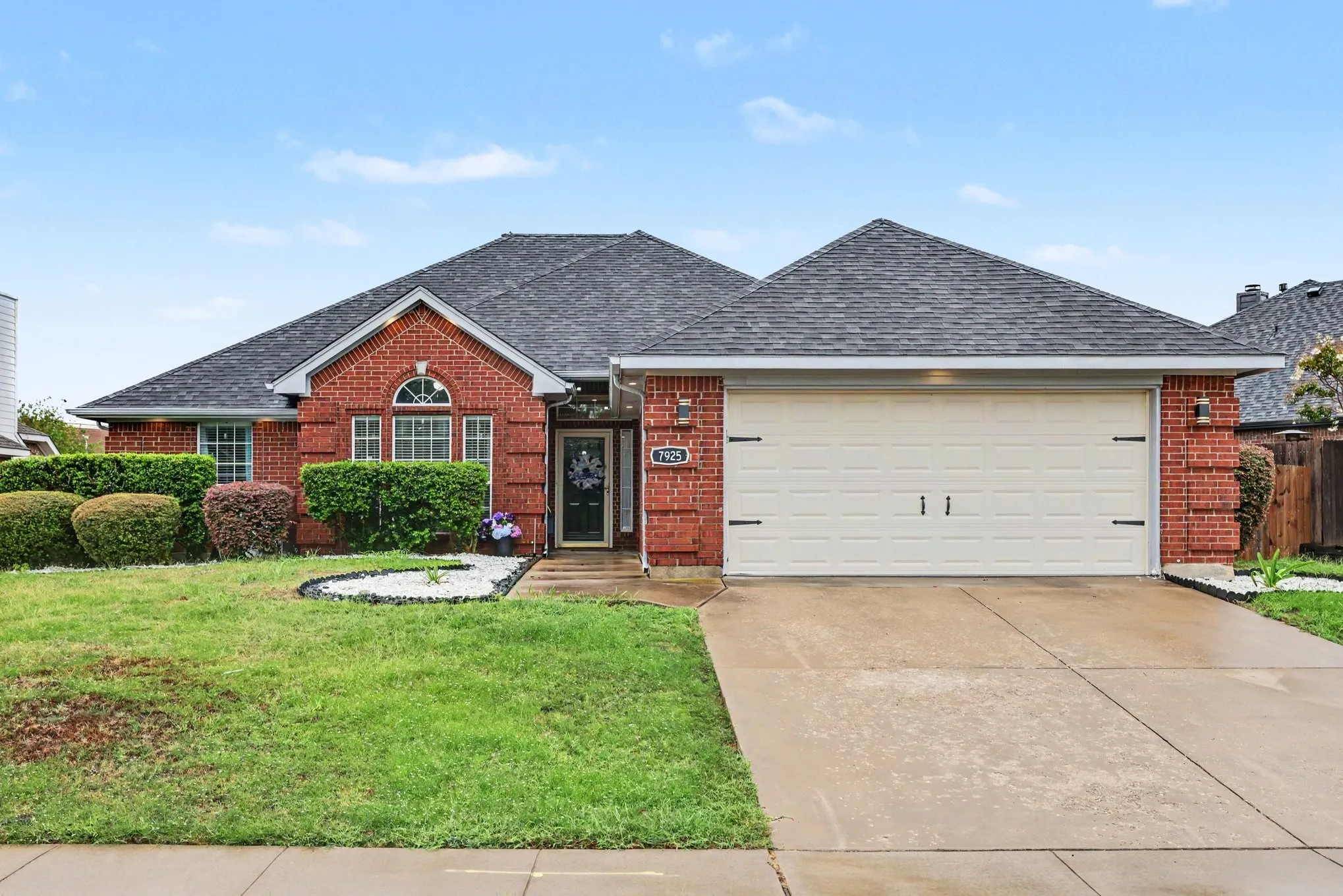 Brick exterior with an attached garage and concrete​​‌​​​​‌​​‌‌​‌‌​​​‌‌​‌​‌​‌​​​‌​​ driveway