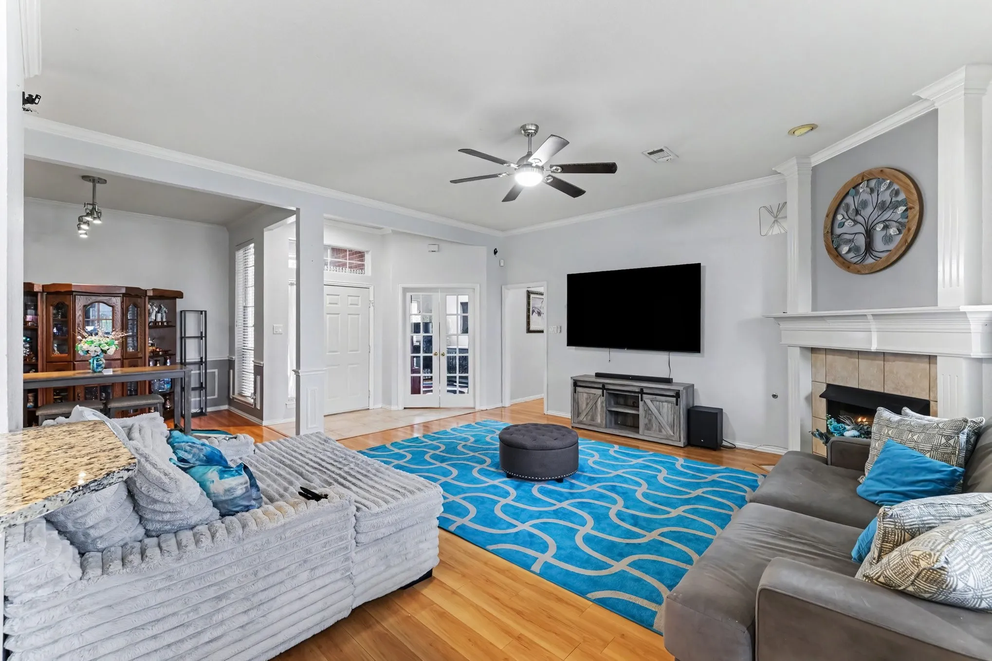 Hardwood flooring with a decorative fireplace and mantel