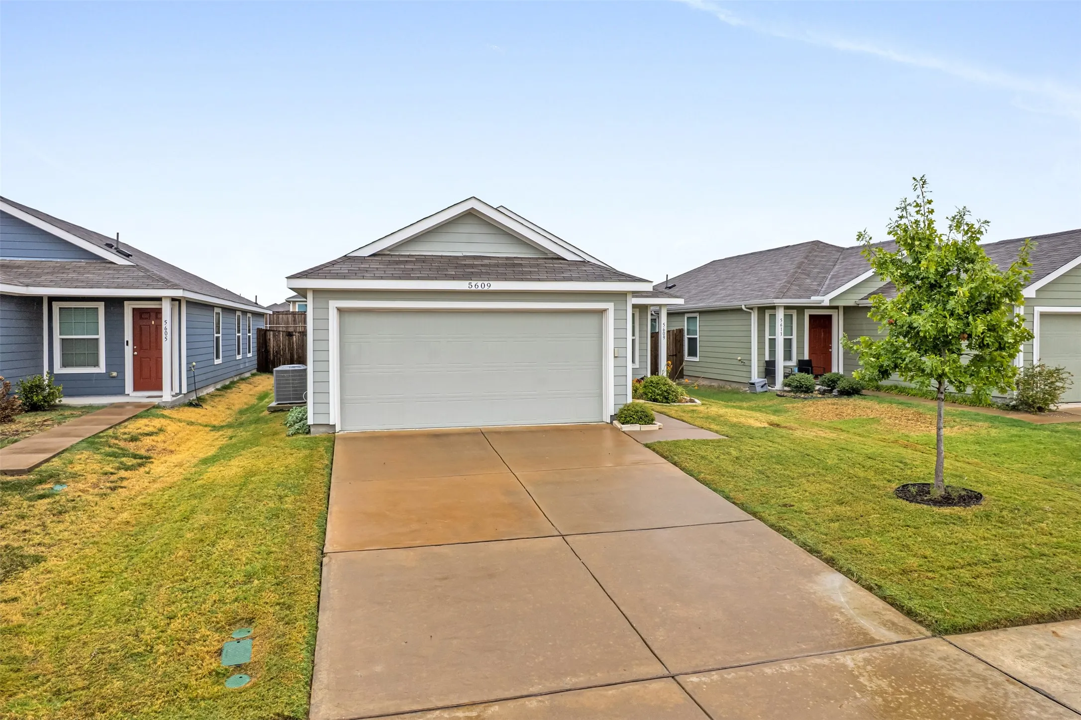 Light gray siding exterior with a light gray garage door