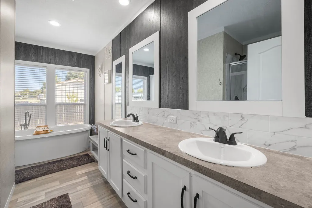 Dual vanity with white cabinetry, ample countertop space, and undermount sinks