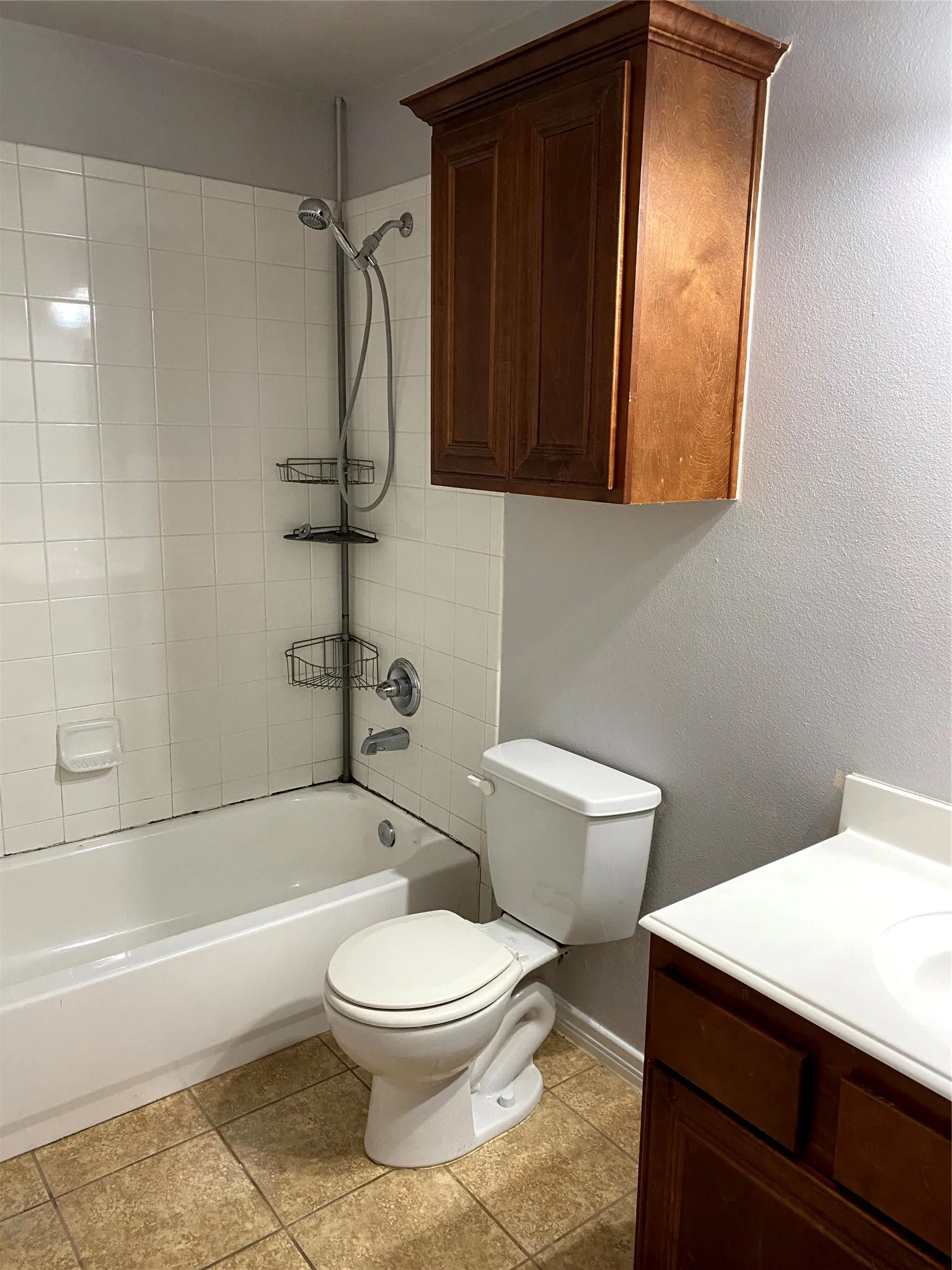 White subway tile shower surround with a handheld showerhead