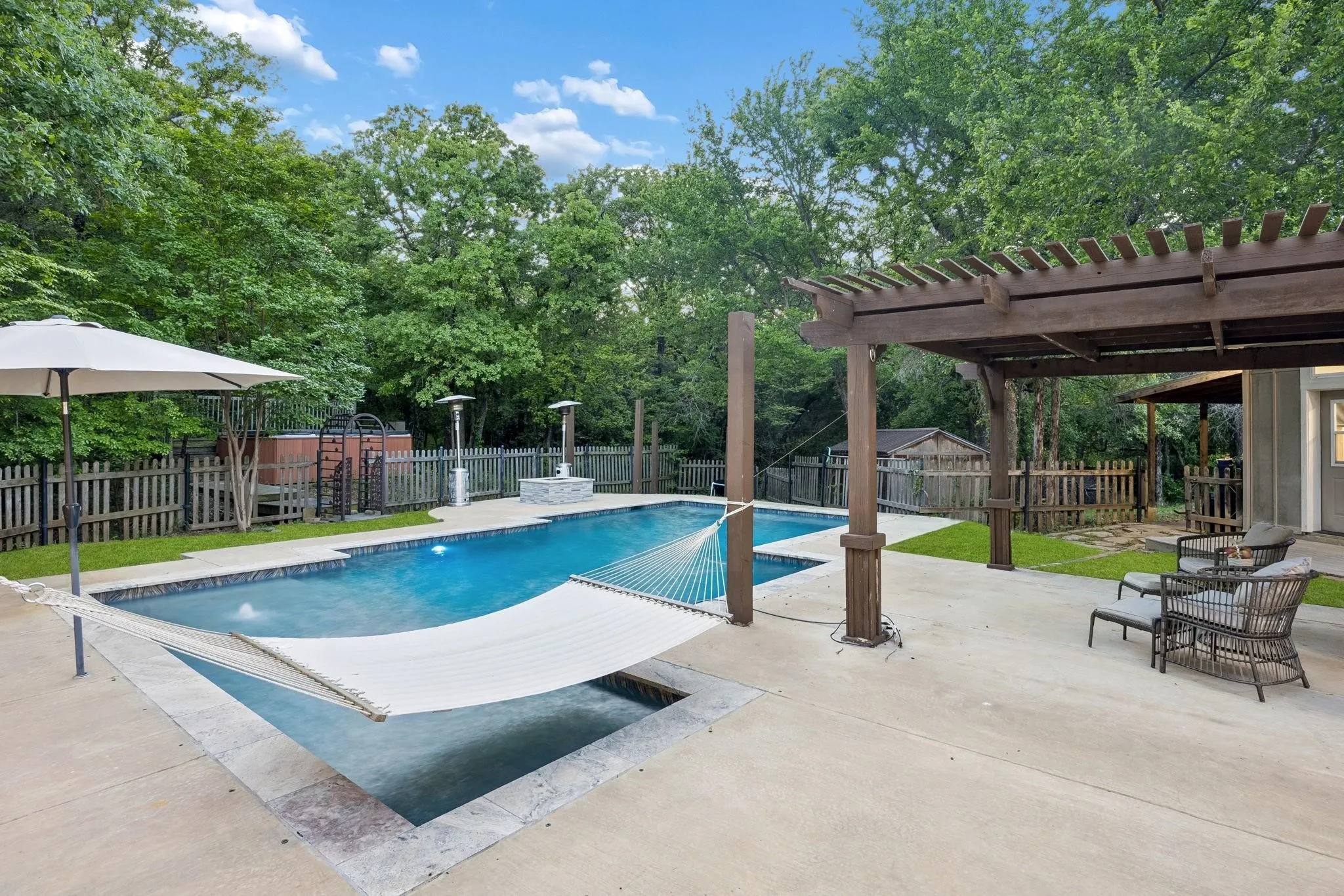 Whether you’re enjoying your morning coffee in the hammock, cooling off in the pool, or ending the evening around the fire pit, this backyard offers countless ways to relax and unwind.