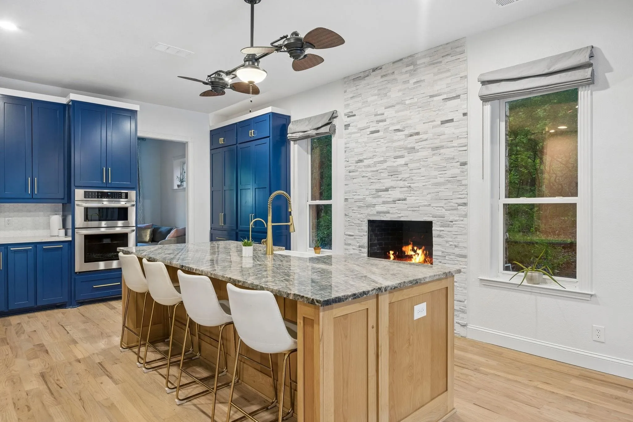Gorgeous remodeled kitchen with a fireplace, creating an inviting gathering space.