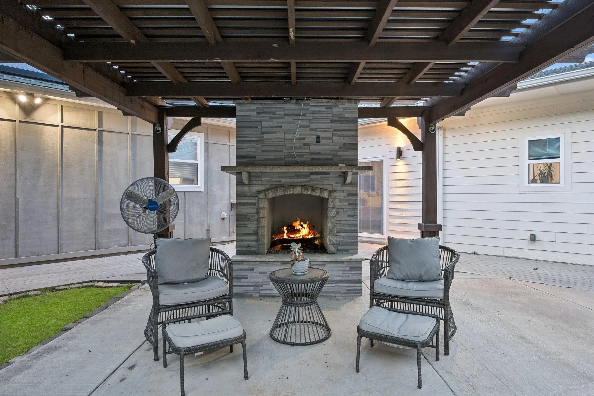 Resort-style pool complemented by a cozy outdoor fireplace, creating the perfect backyard retreat.