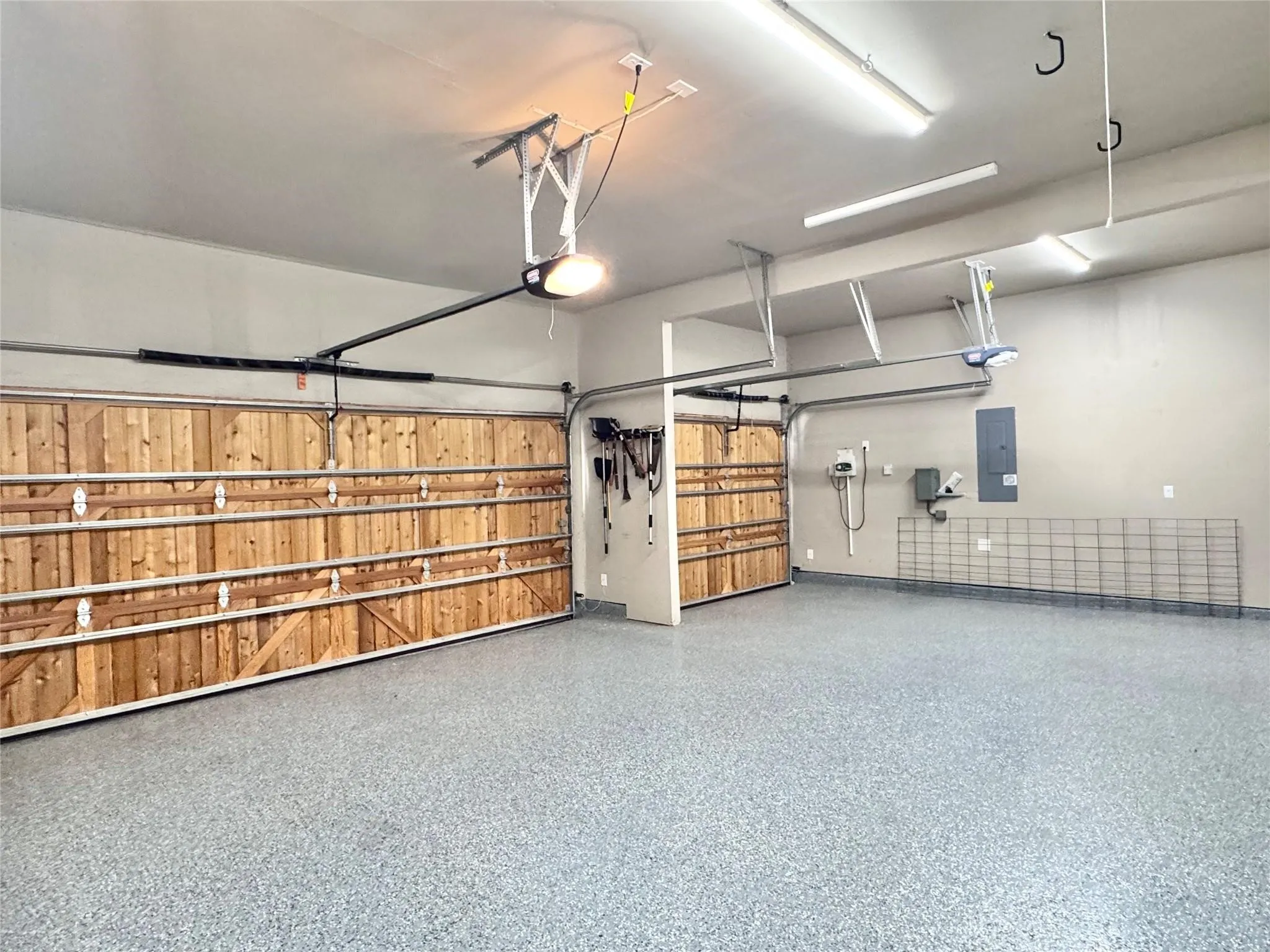 Professionally installed epoxy garage flooring in the three car garage with mini-split proving heat and air to the garage!