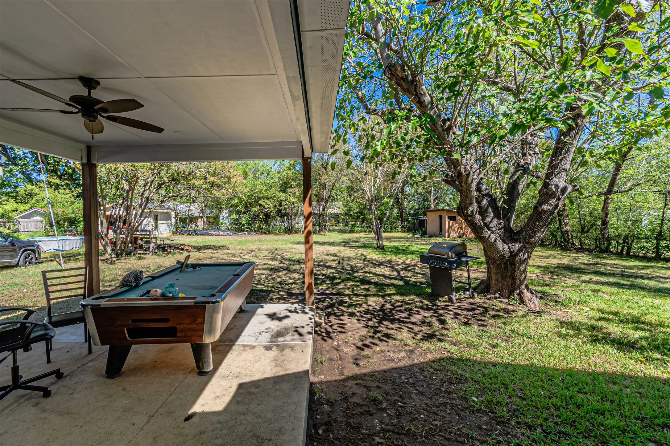 Covered patio with ceiling fan, concrete flooring, and wooden support columns