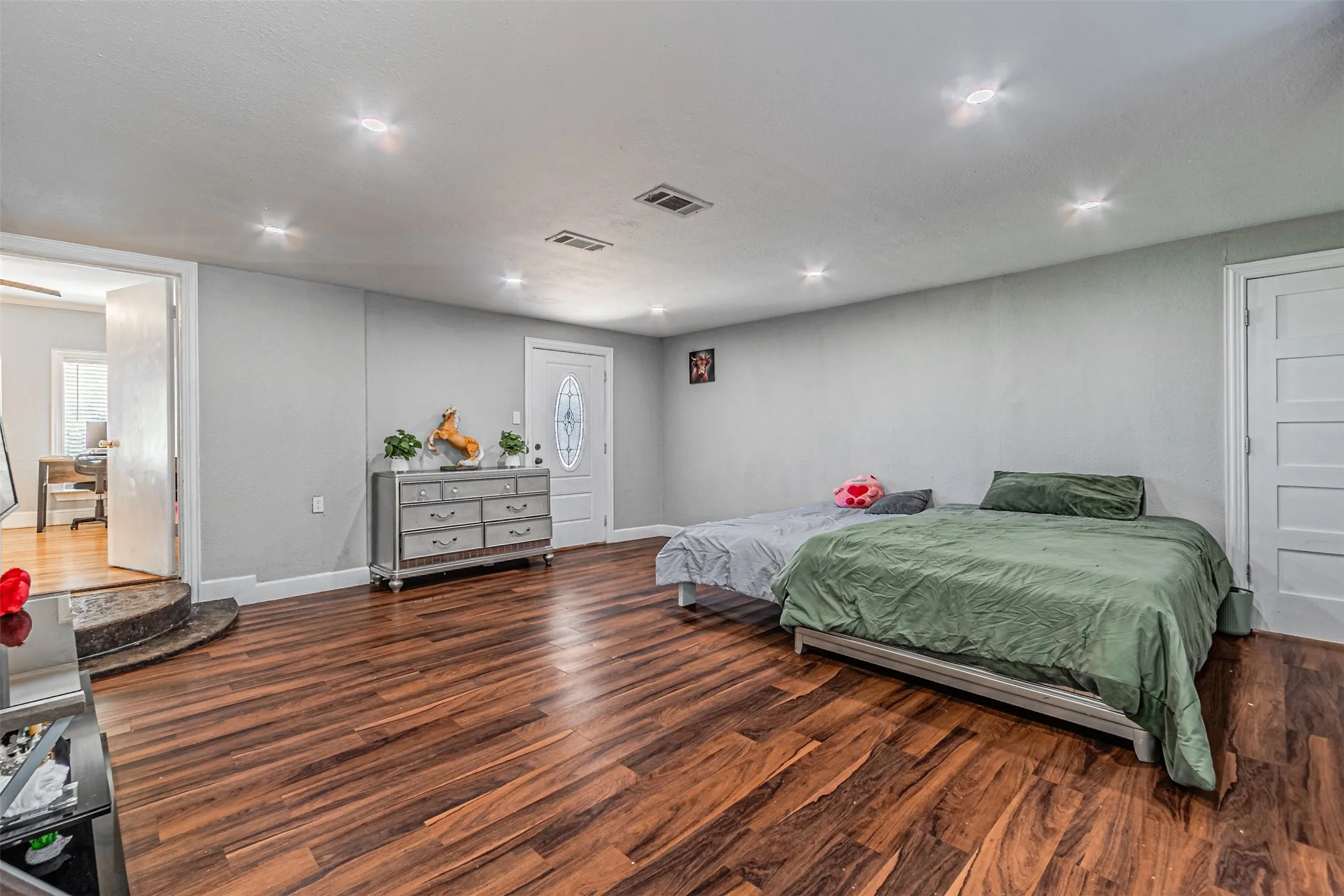 Wood-finish flooring throughout, recessed lighting, and light gray walls
