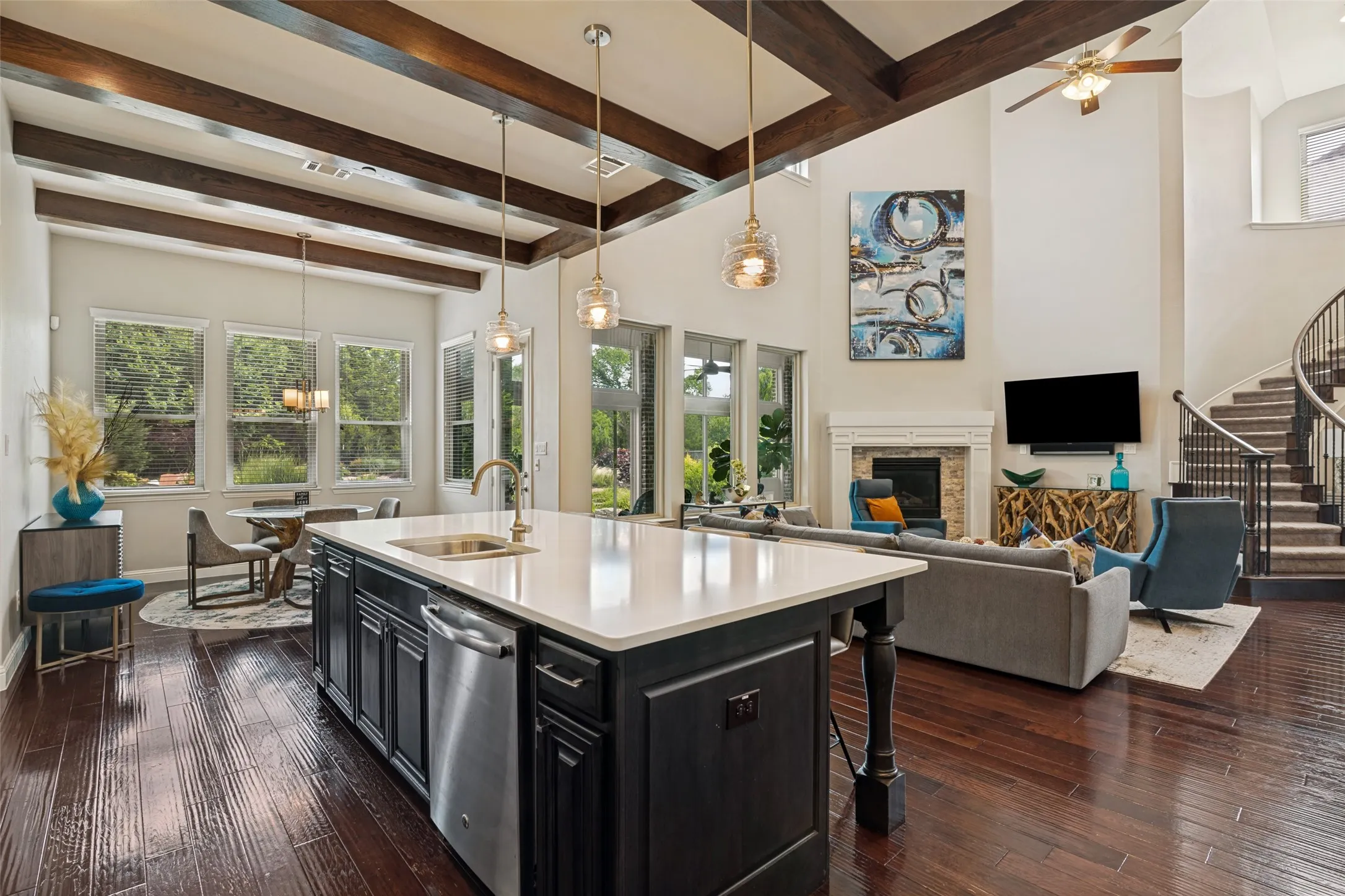 Open-concept living area with high ceilings and exposed wood beams