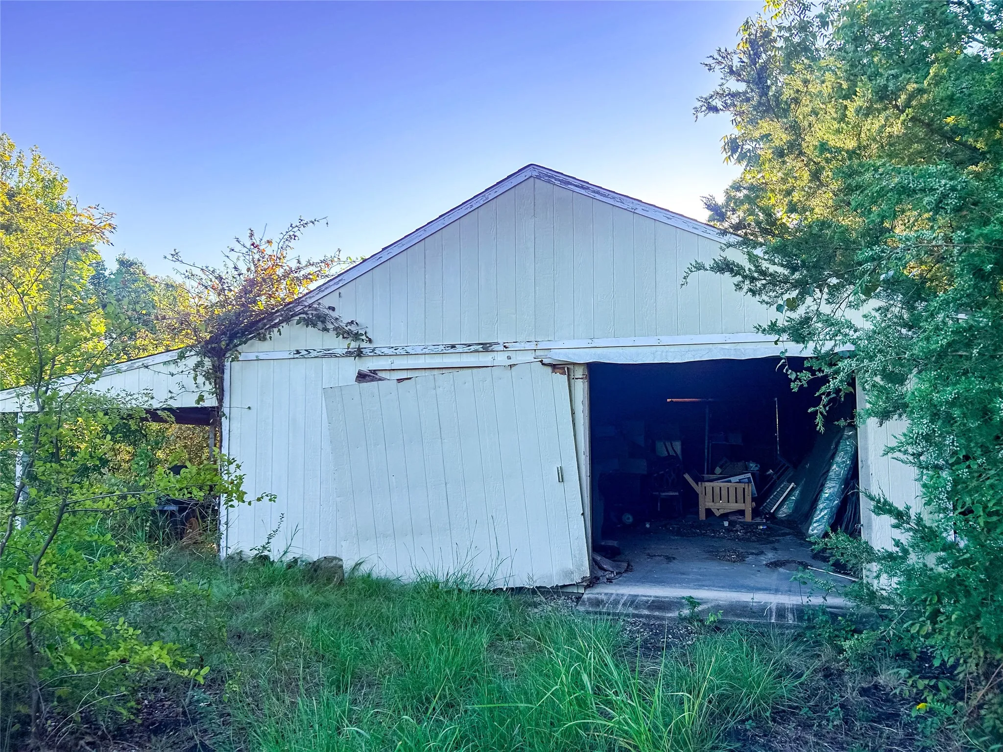 Shed structure featuring a gabled roof and board-and-batten siding