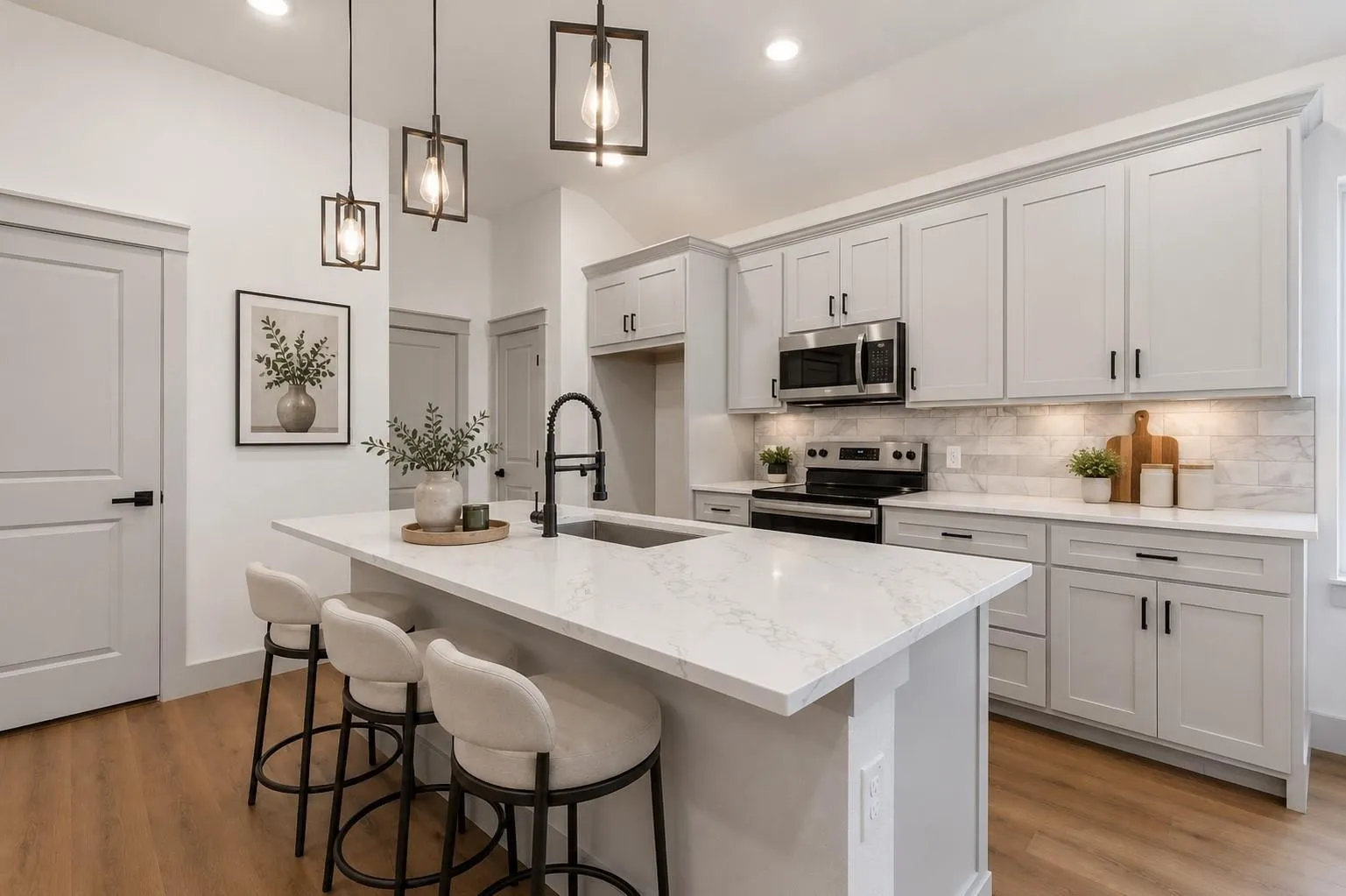Virtual image Kitchen featuring an island with a stone countertop and an undermount sink, pendant lighting, light-toned cabinetry with dark hardware, a subway tile backsplash, and wood-finish flooring