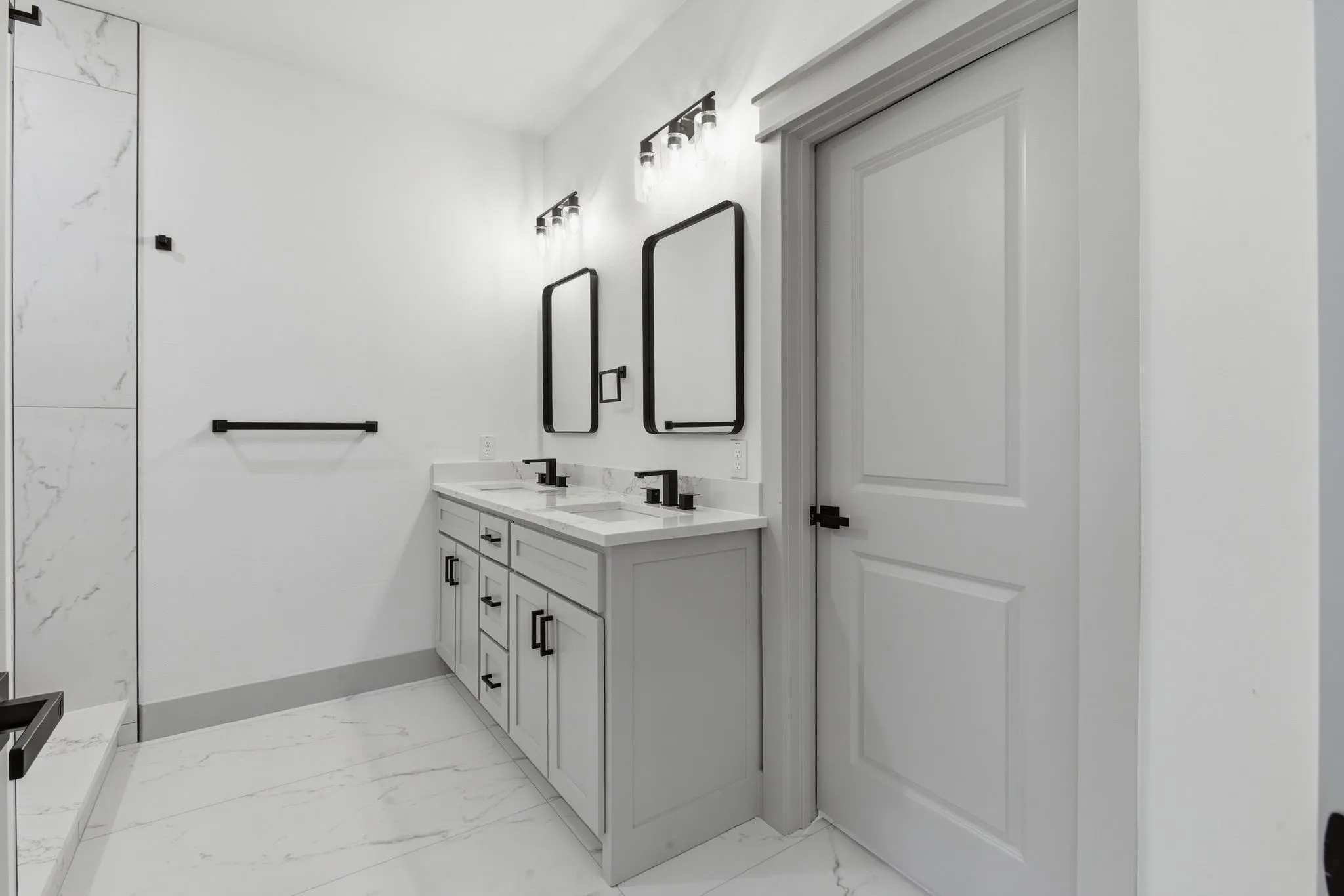 Dual vanity with white undermount sinks and matte black fixtures