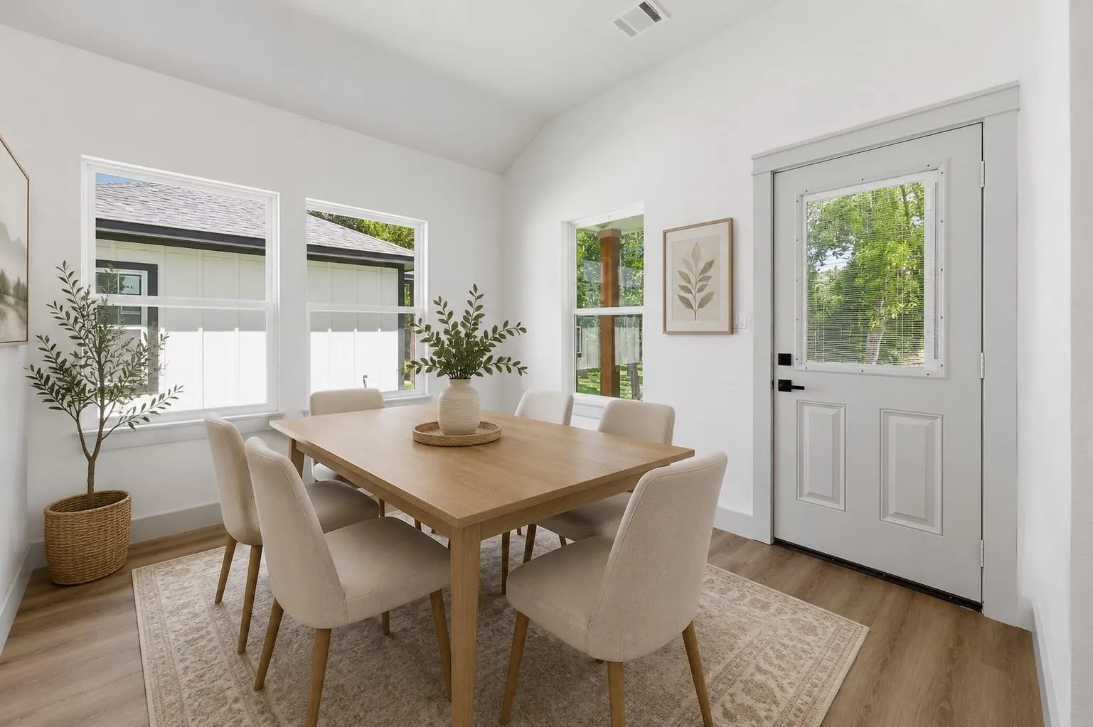 Virtual image Vaulted ceiling with recessed lighting, wood-finish flooring, multiple windows, and a paneled exterior door with an inset window