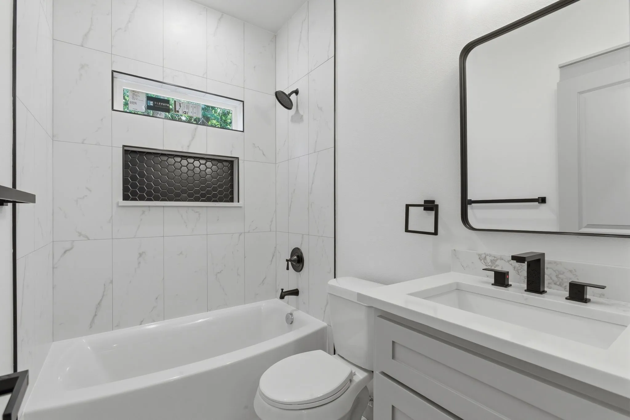 White porcelain tub with a black matte shower head