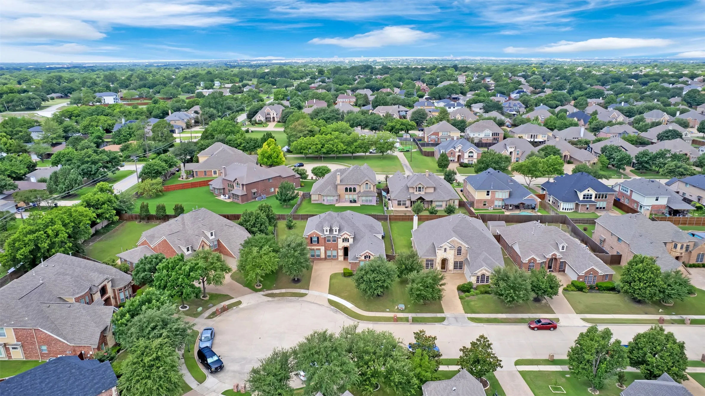Residential neighborhood featuring mature trees and a curvilinear street layout