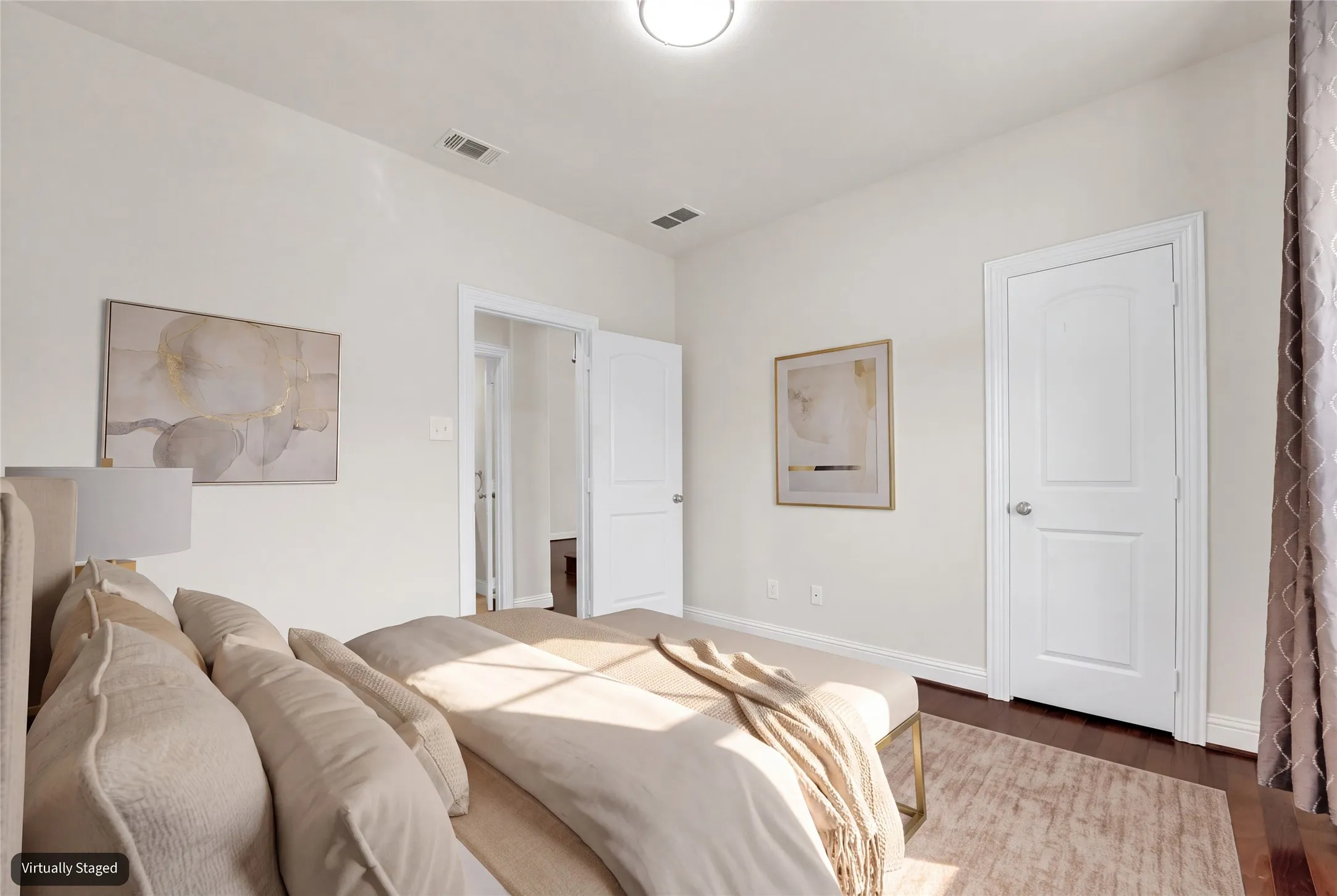Dark wood-finish flooring with light wall tones and white​​‌​​​​‌​​‌‌​‌‌​​​‌‌​‌​‌​‌​​​‌​​ trim
