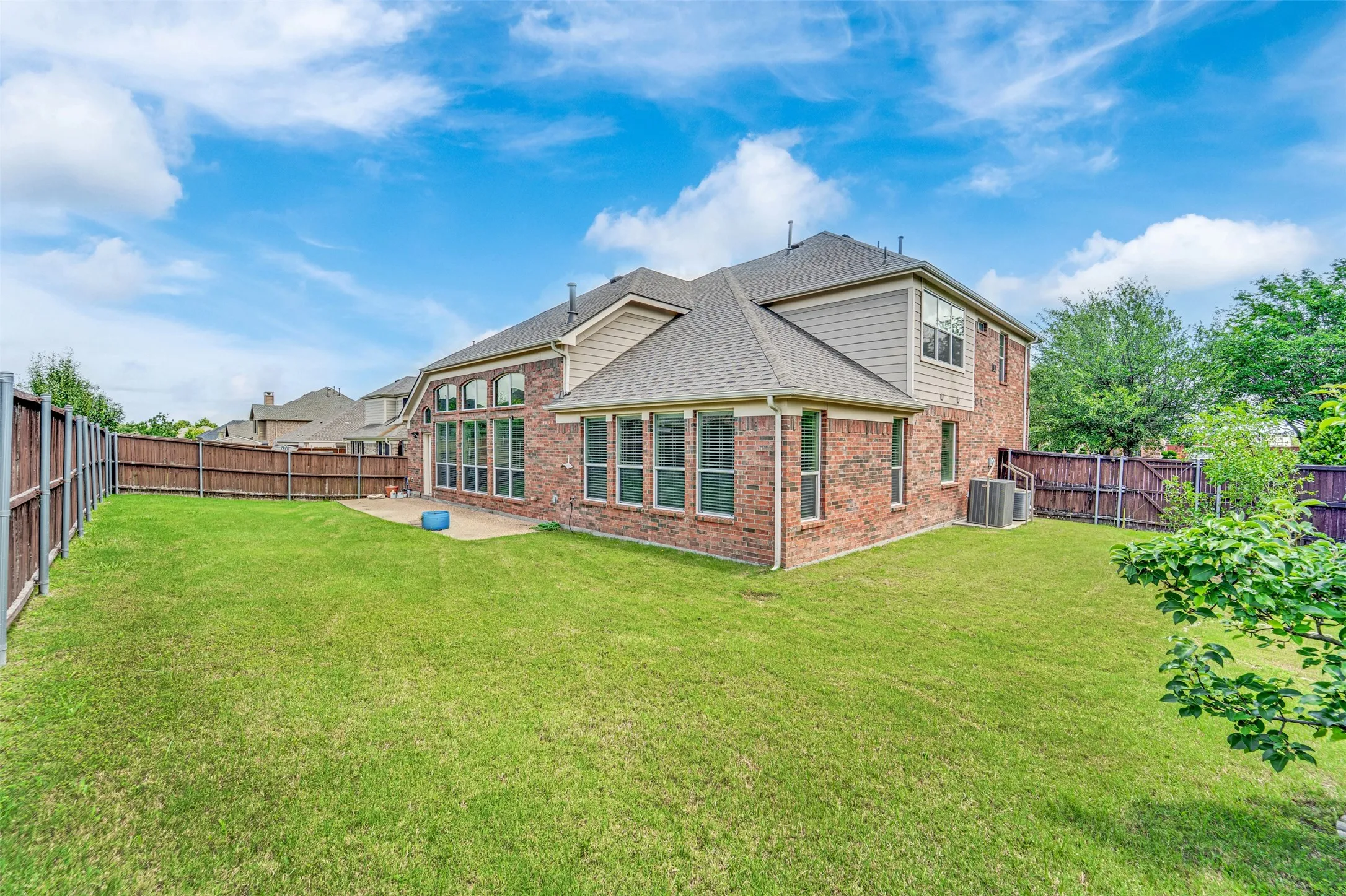 Expansive green lawn with a patio area