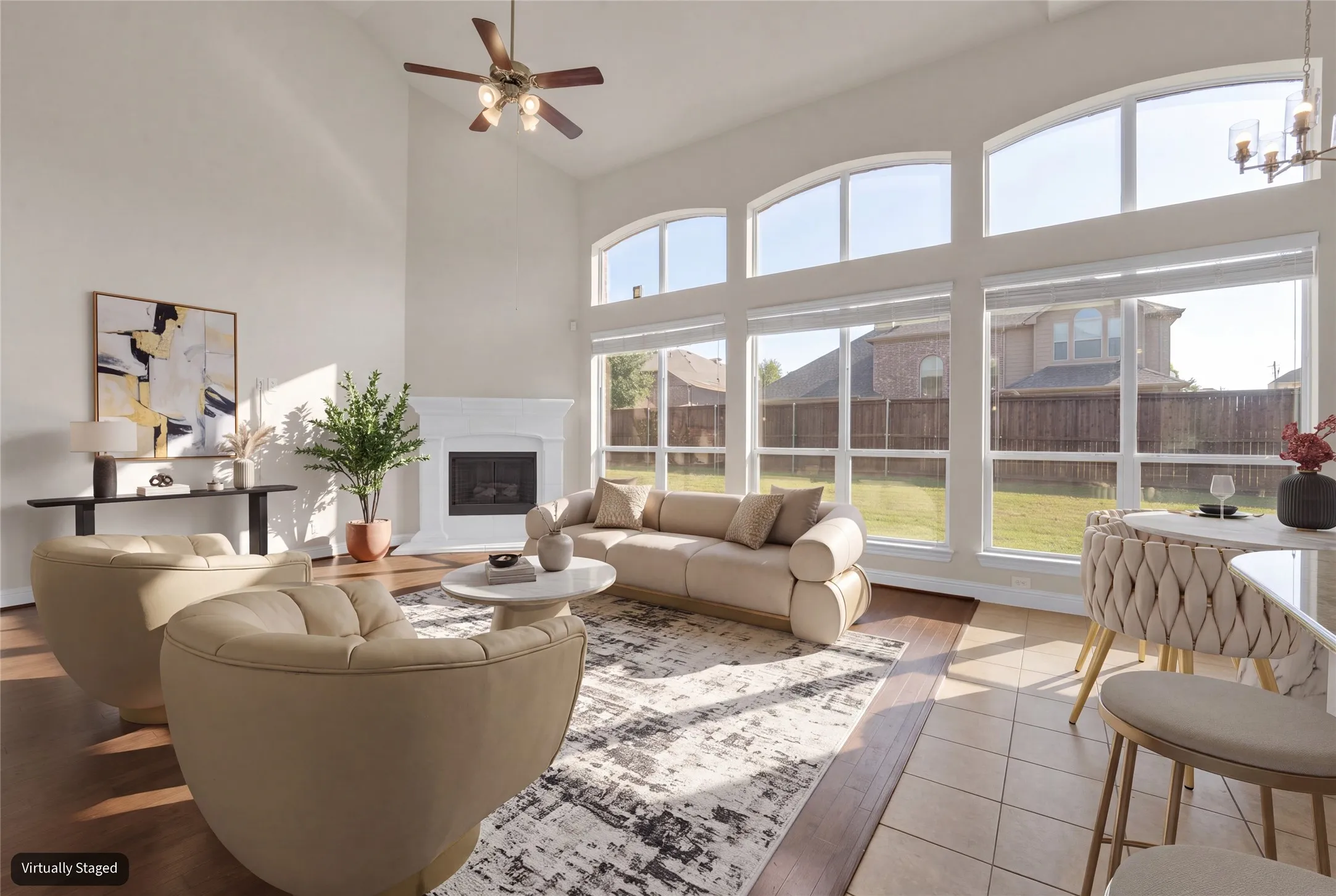 Vaulted ceiling, arched windows, wood-finish flooring, tiled flooring, fireplace with mantel