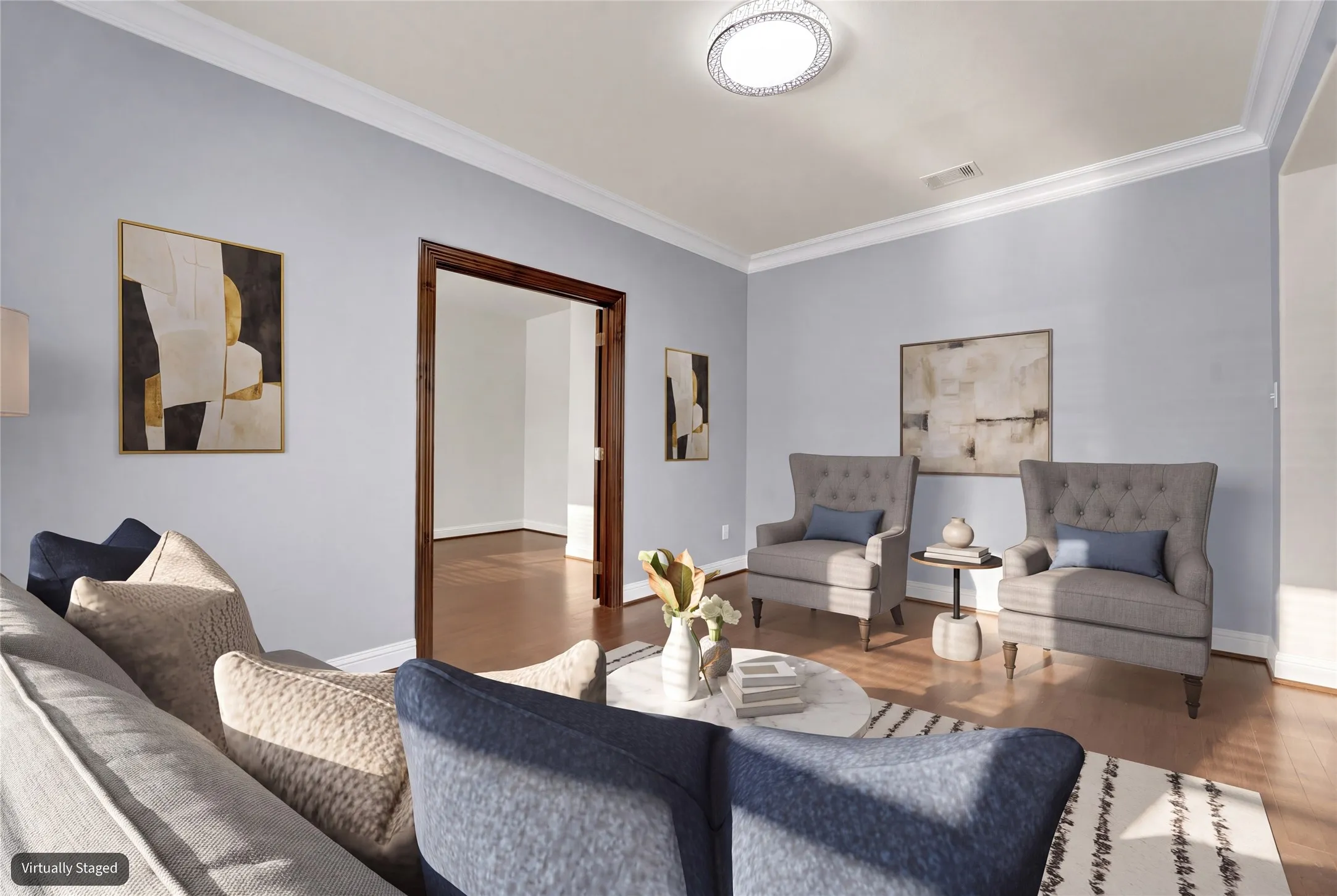 Hardwood-finish flooring, crown molding, and a flush mount light fixture