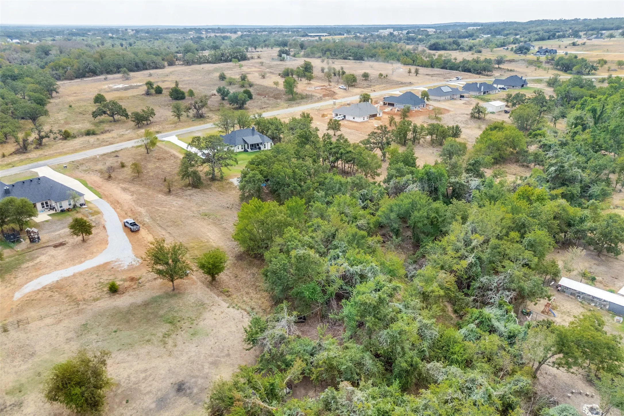 Expansive undeveloped lot featuring mature trees and a flat topography