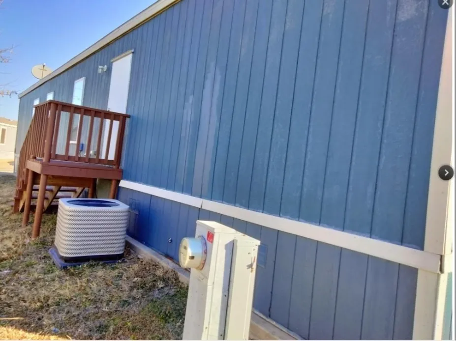 Blue vertical panel siding with white trim