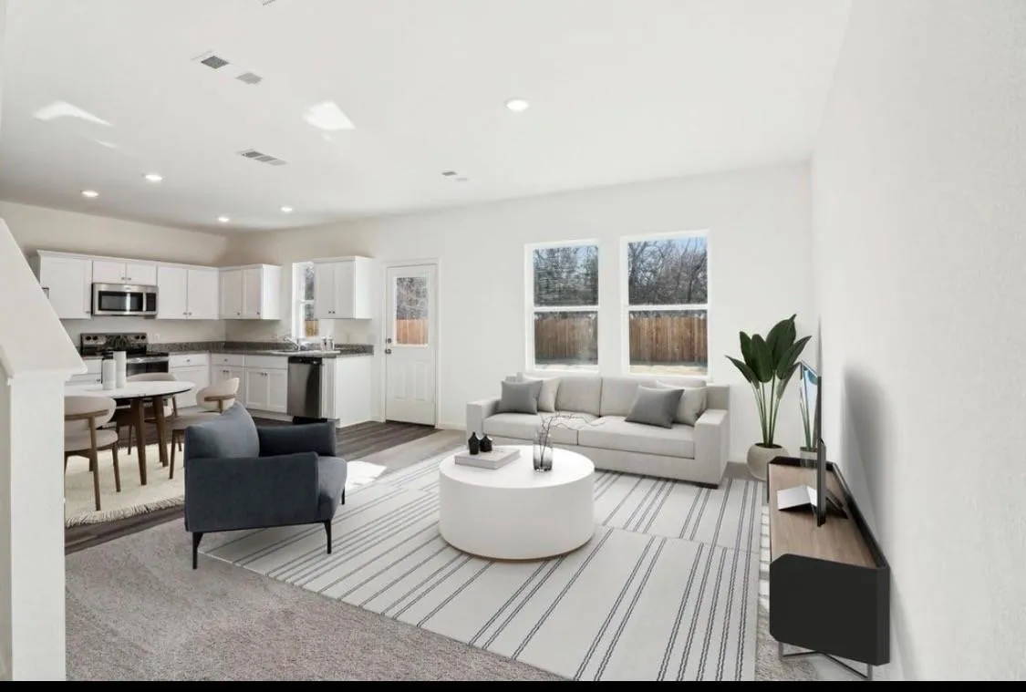 Open-concept living space featuring recessed lighting, light-toned walls, and wood-finish flooring