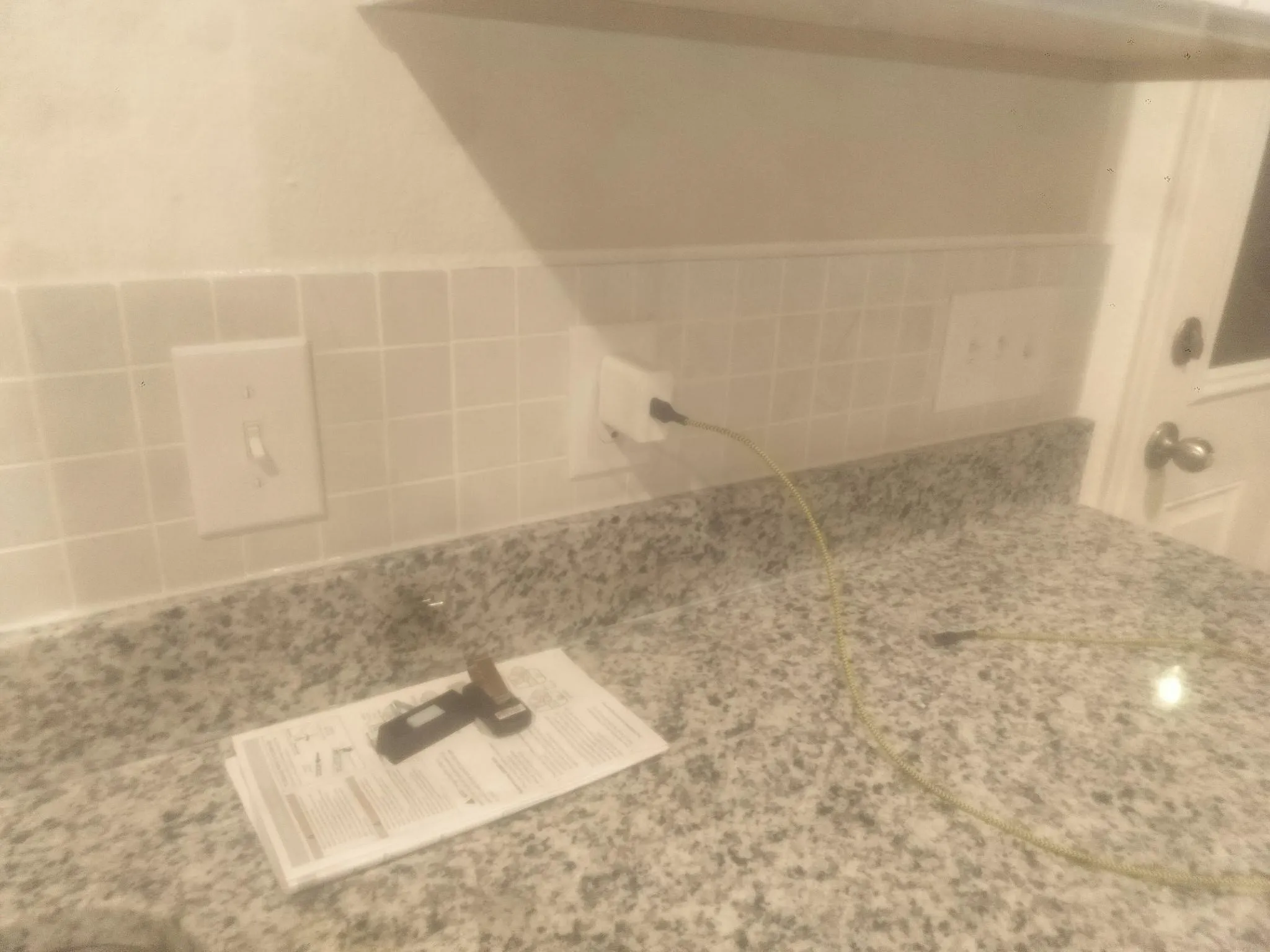 Granite-finish countertop with a tiled backsplash
