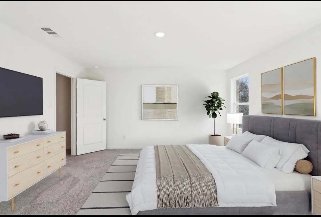 Recessed ceiling lighting, light-toned carpeting, a window, and a paneled interior door