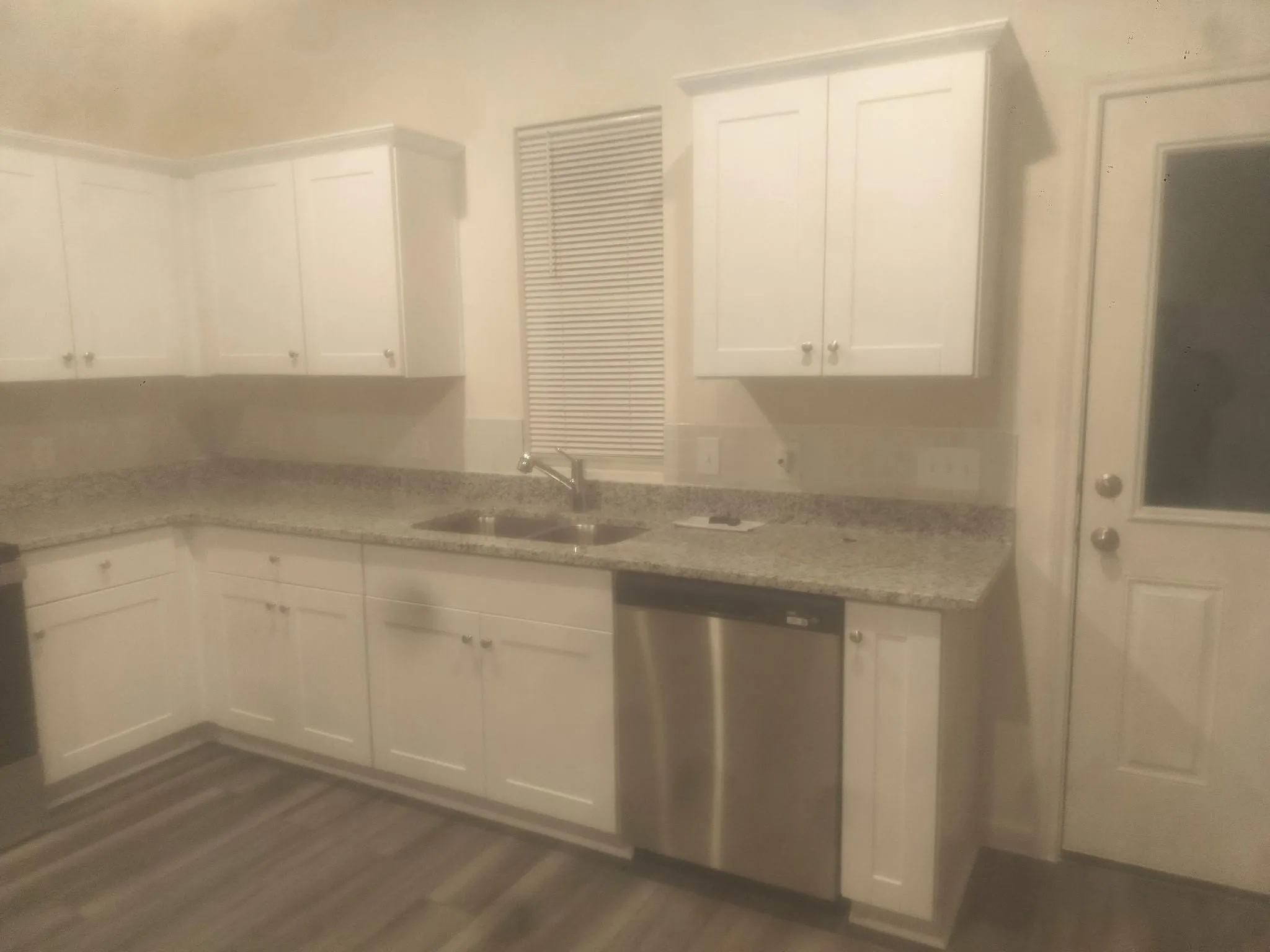 White cabinetry and wood-finish flooring