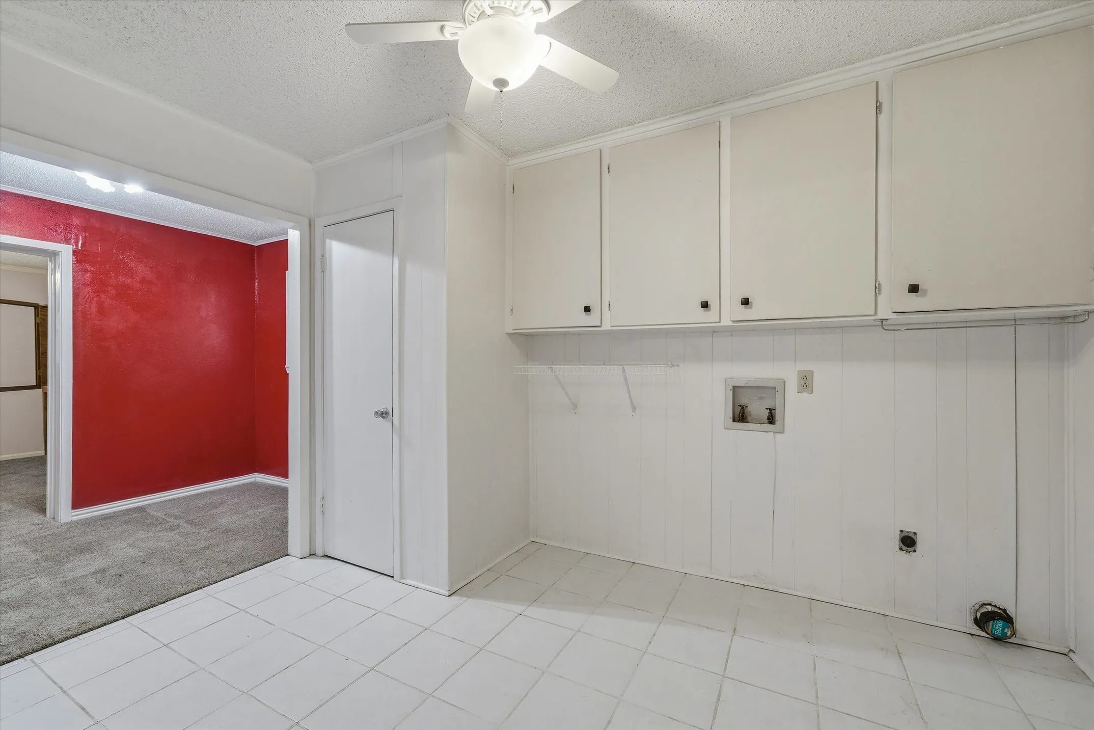 White tile flooring with white paneled walls